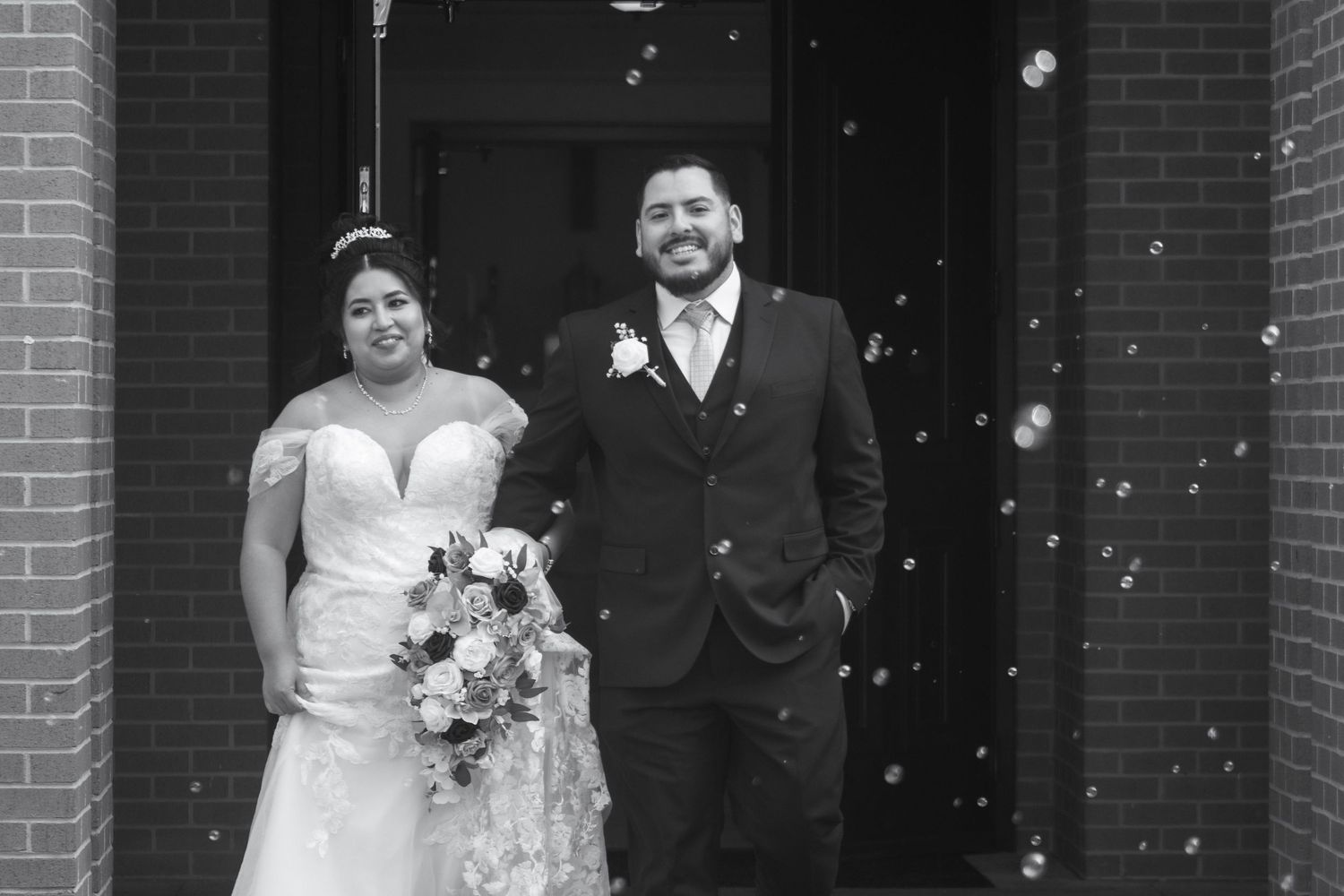 A black and white photo collage showing three wedding couples posing in front of a brick building.
