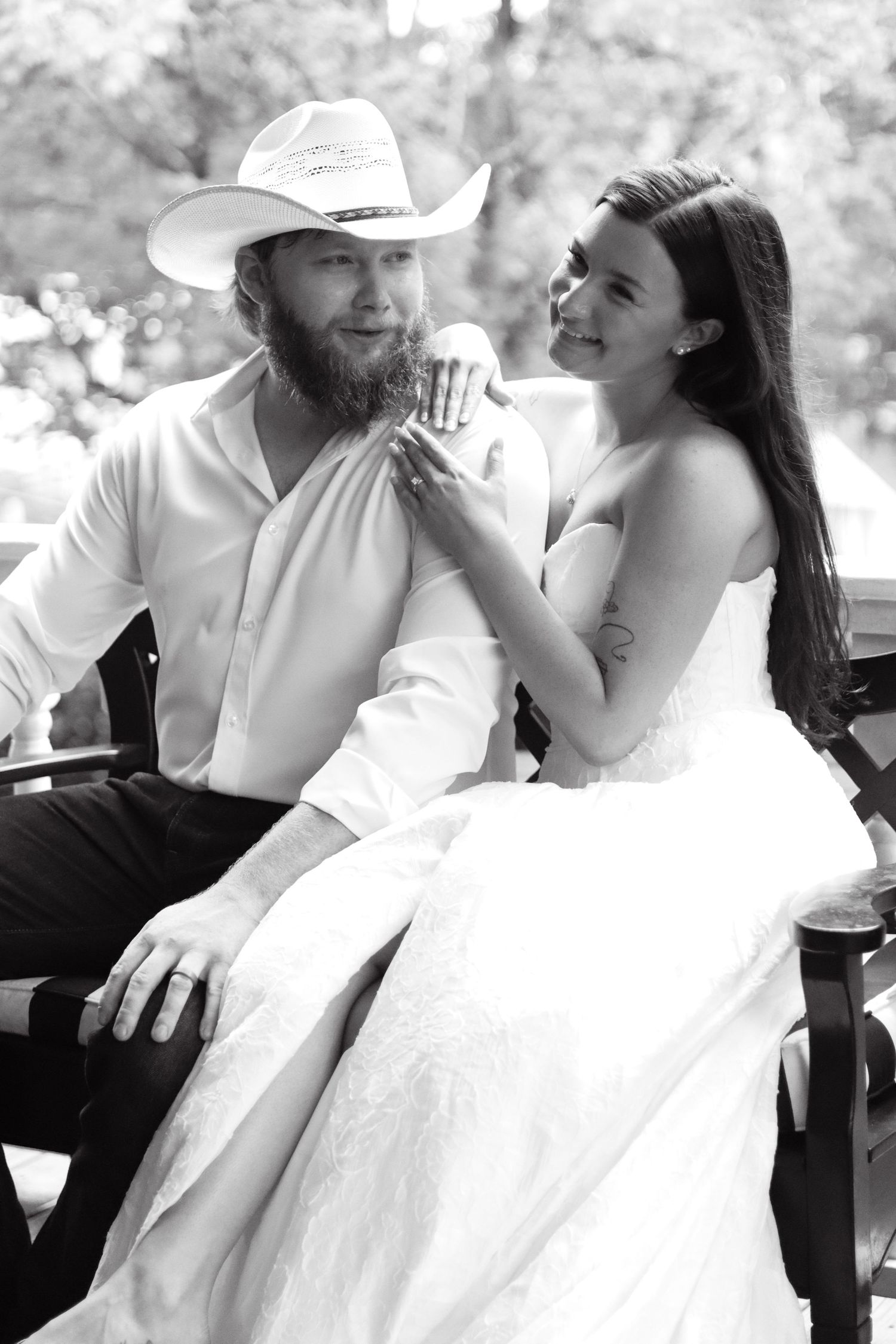 Black and white wedding photos capturing candid romantic moments between newlyweds.