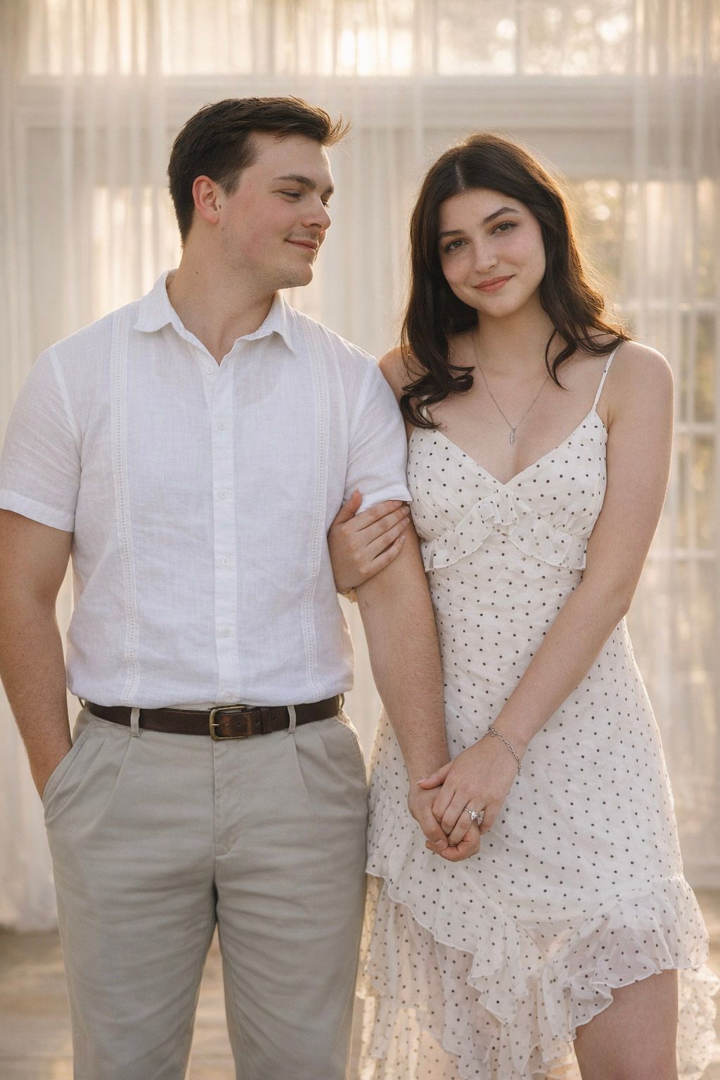 A couple in white and beige outfits shares romantic moments in a sunlit room with sheer curtains.