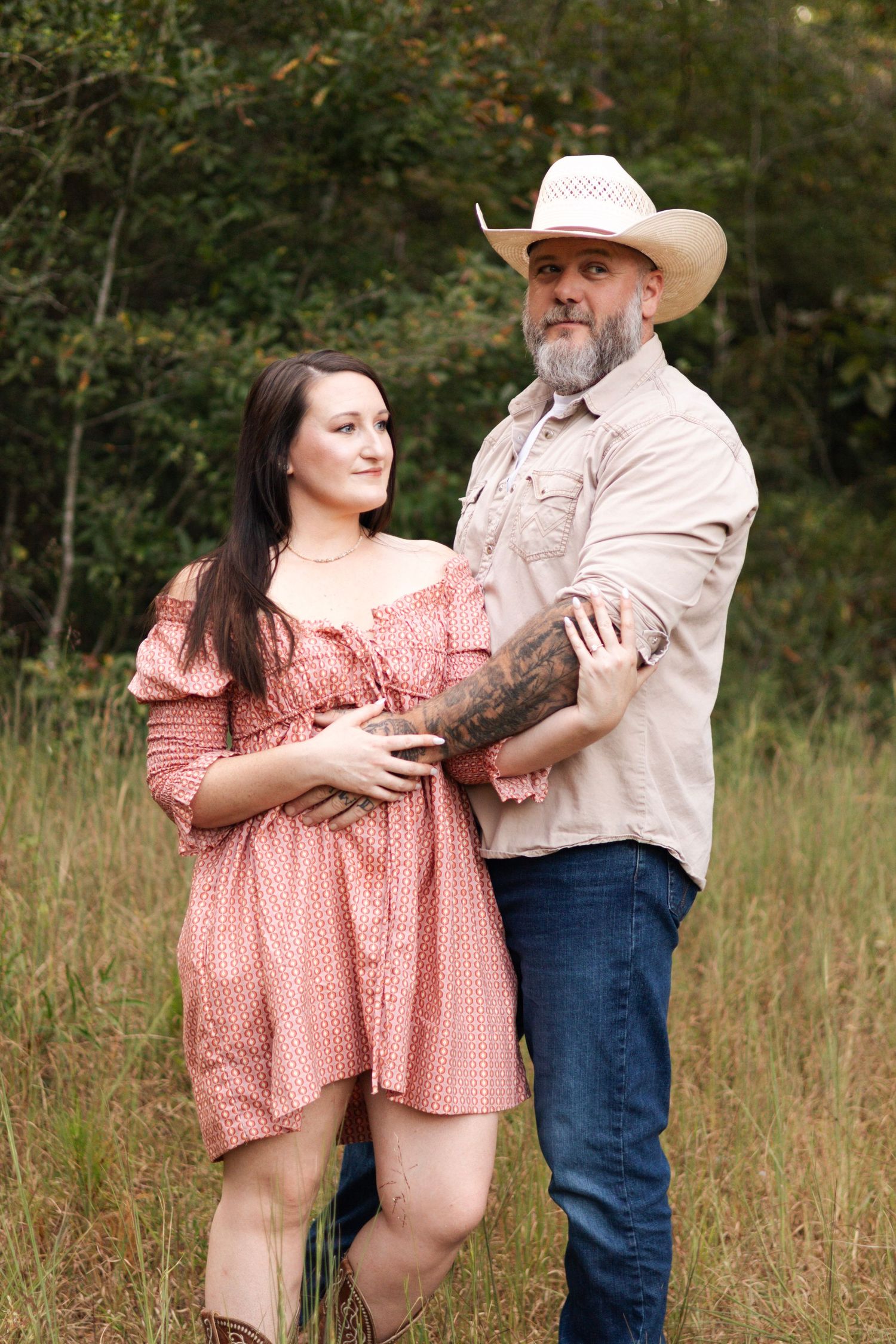 Romantic outdoor photoshoot with couple in country western attire.