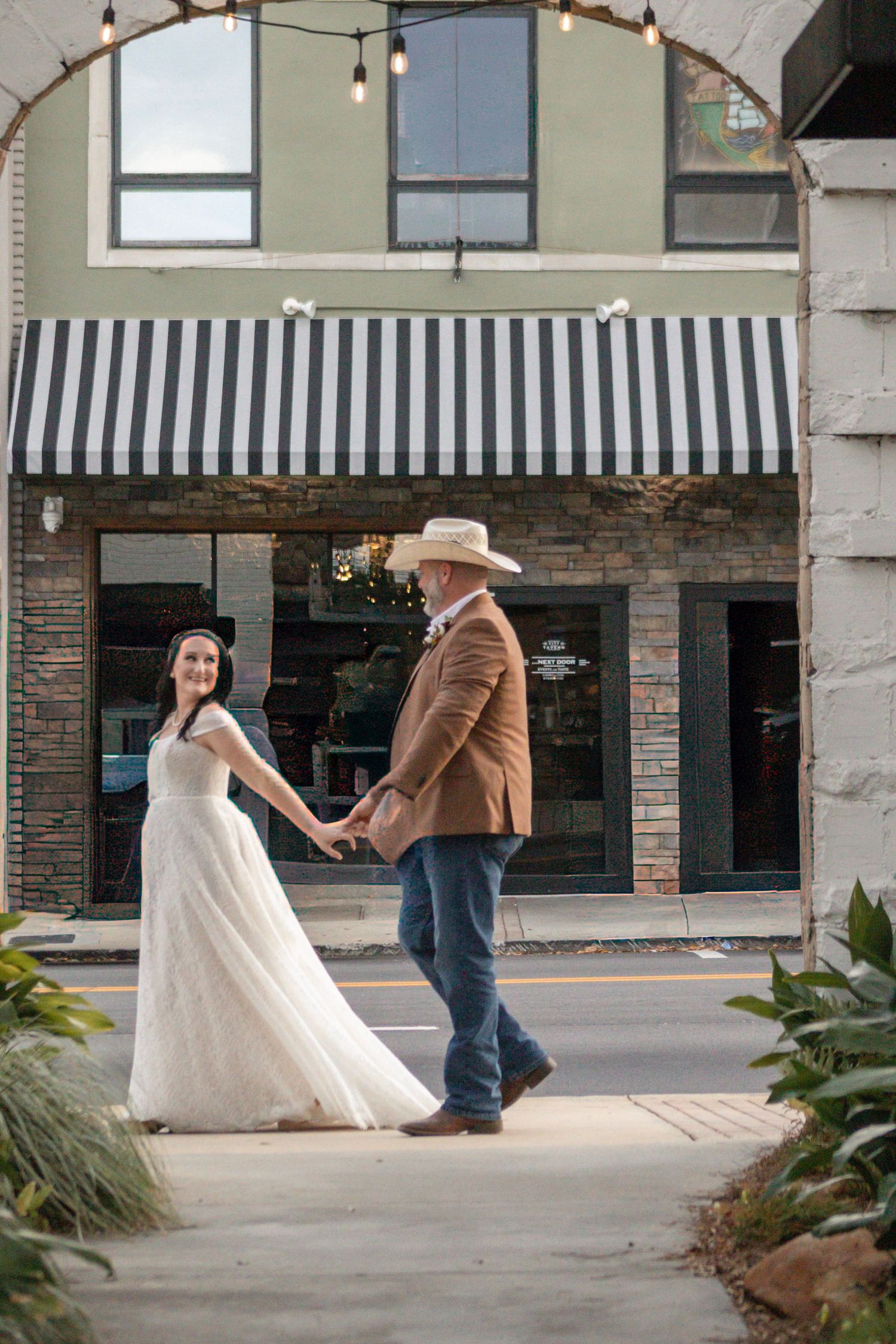 A series of wedding dance photos under string lights at an outdoor venue.