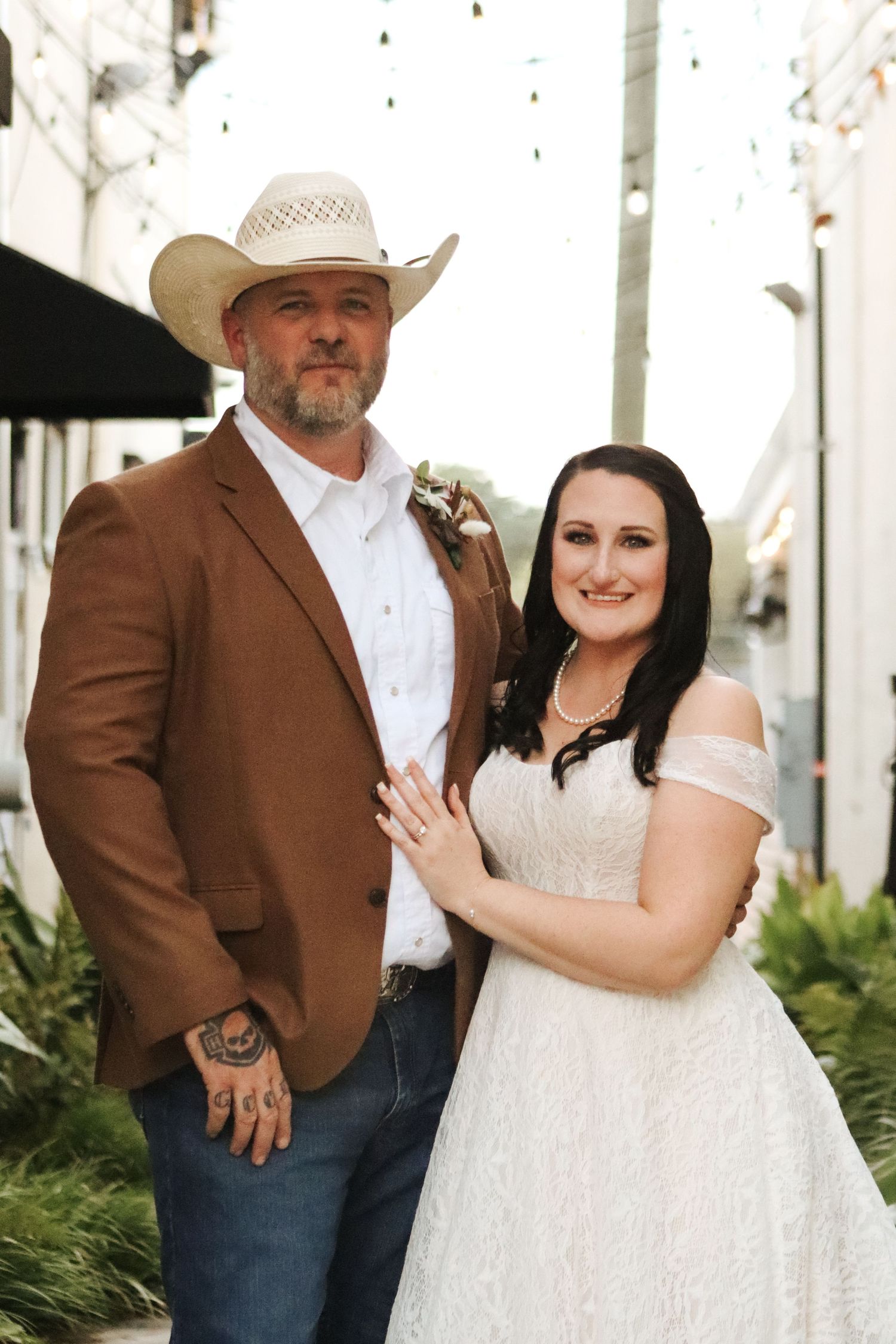 Rustic wedding portraits featuring brown suit jacket and white lace dress.