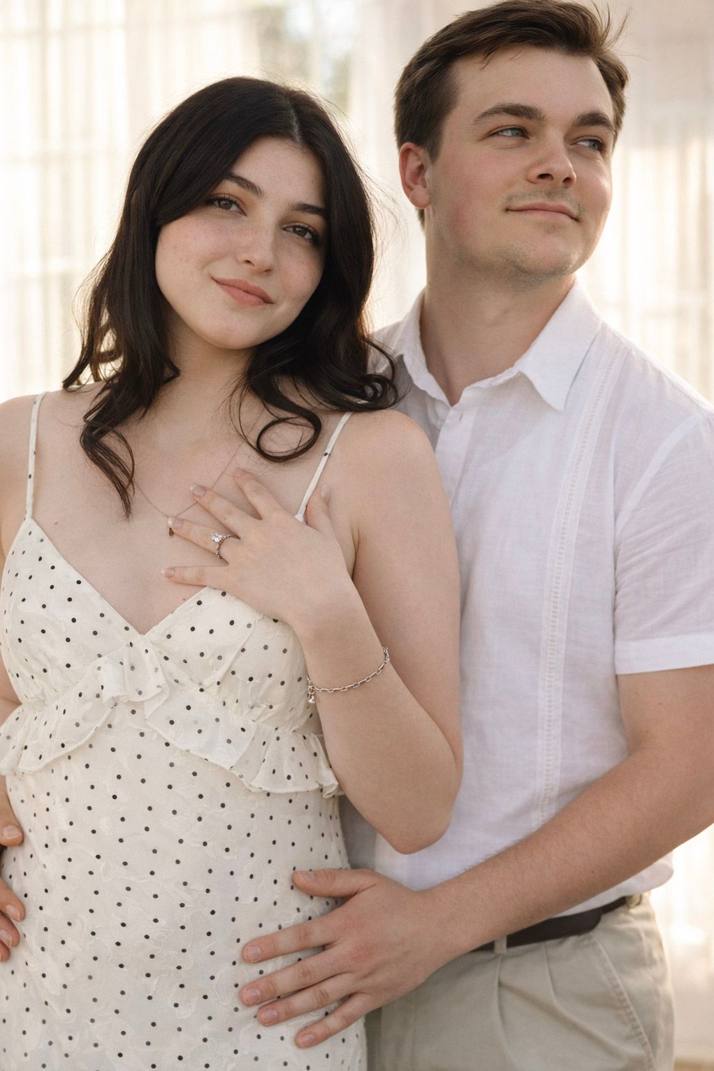 Romantic couple in white clothing embraces tenderly in a bright studio setting with multiple poses shown.