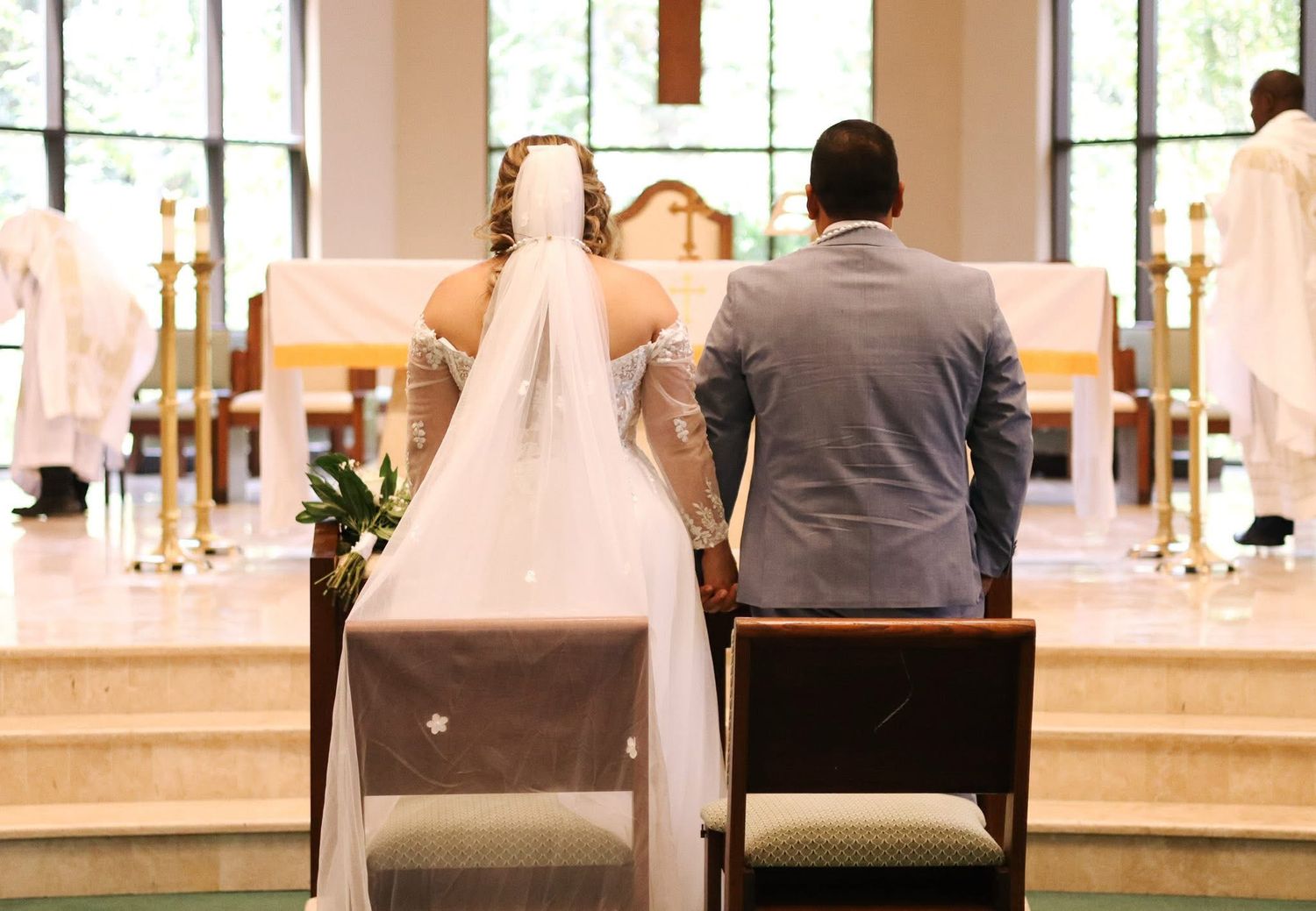 Interior of modern church sanctuary with large windows and white walls.