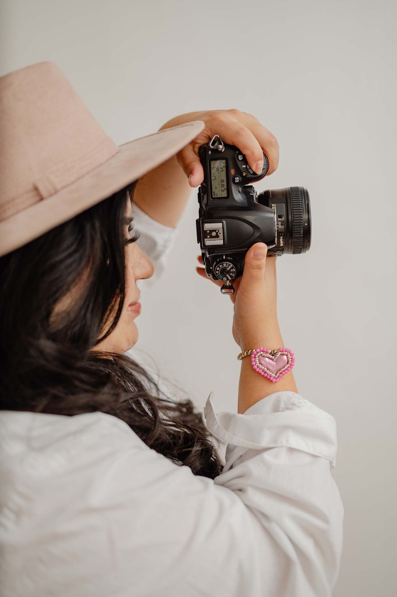 Sharom Rosas, founder of Shamari Visuals, photographing a client session in Phoenix, AZ, behind the scenes moment.