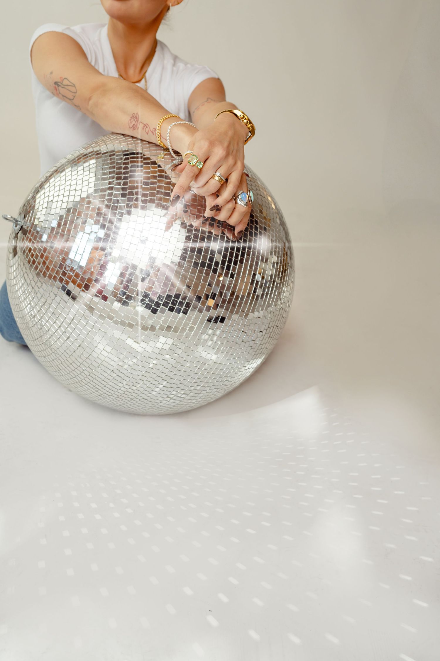 Minimalist studio shot of woman holding a disco ball in natural light, captured at Afternoon Studios in Phoenix.
