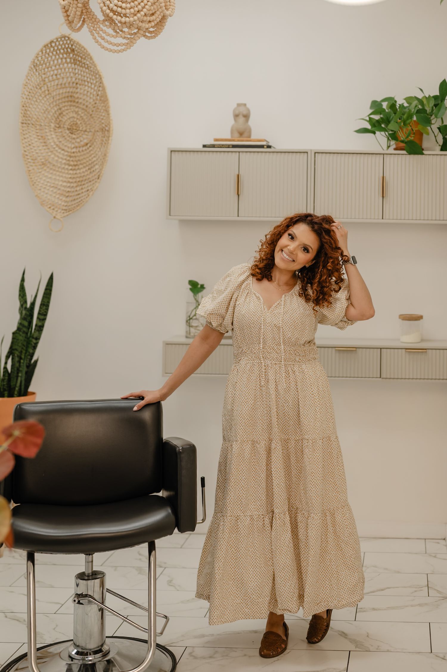 Full-body brand portrait of Serena inside her Peoria studio, framed by plants and earthy tones.
