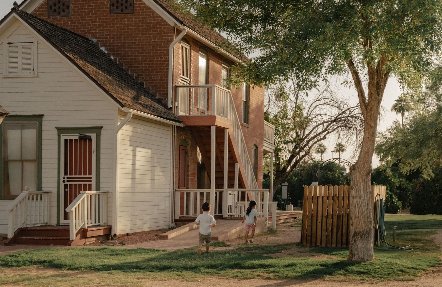 Historic house and kids playing at Sahuaro Ranch Park in Glendale, AZ.
