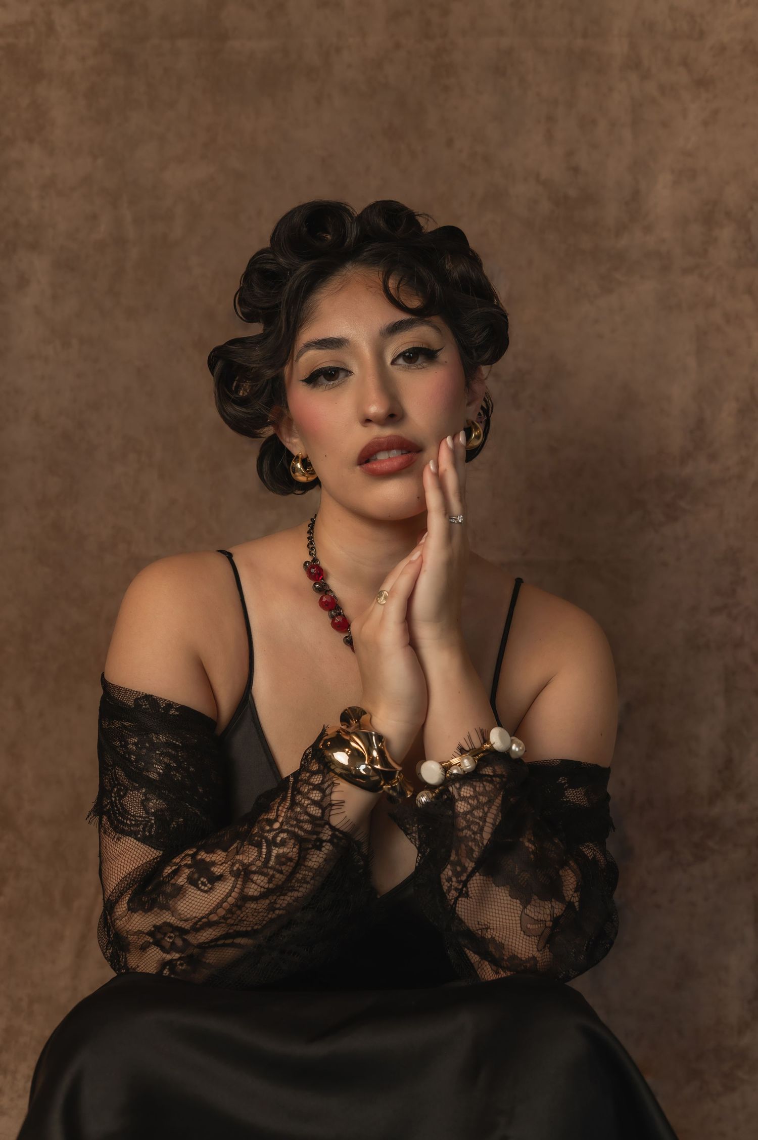 Soft close-up of the same woman in a pin-up look, eyes closed and serene — captured at The Hive Salon.