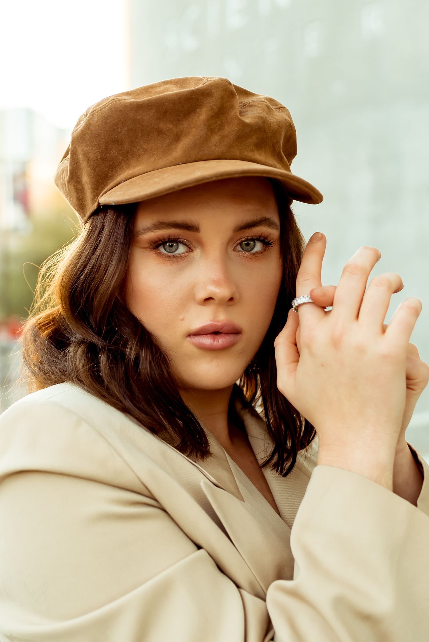 Gracie Collins, stylish portrait in a beige blazer and brown suede cap, urban editorial photography in Arizona.