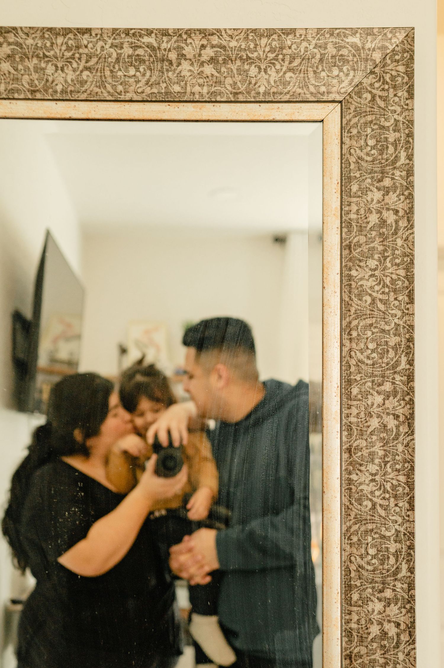Sharom Rosas, founder of Shamari Visuals, with her family taking a mirror selfie, personal photo.