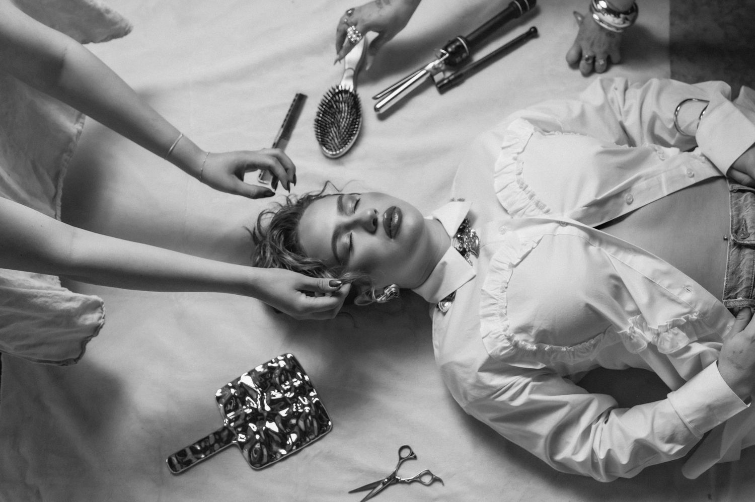 Black and white editorial photo styled by multiple hands, captured inside The Hive salon in Phoenix.