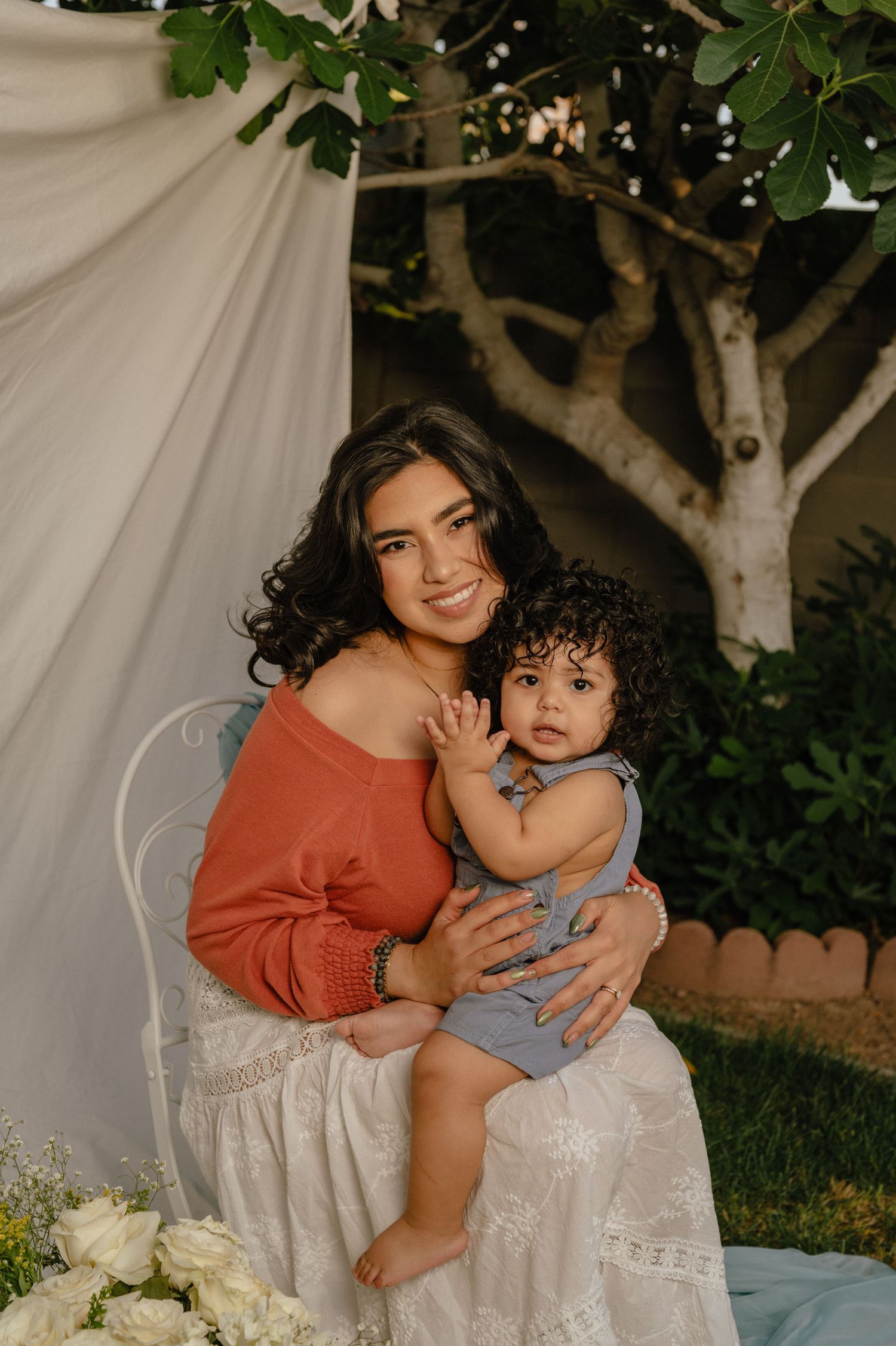 Amariz Jones, owner of The Hive Salon, holds her toddler close in a candid family moment.