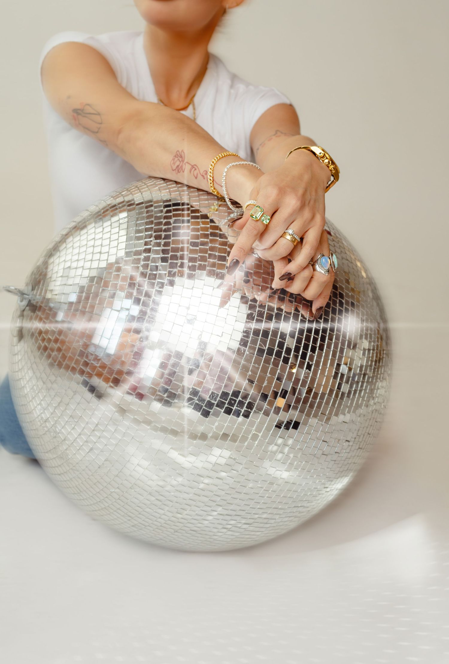 Diana Alzolay, close up resting hands on a disco ball, brand photography at Afternoon Studios in Phoenix, AZ.