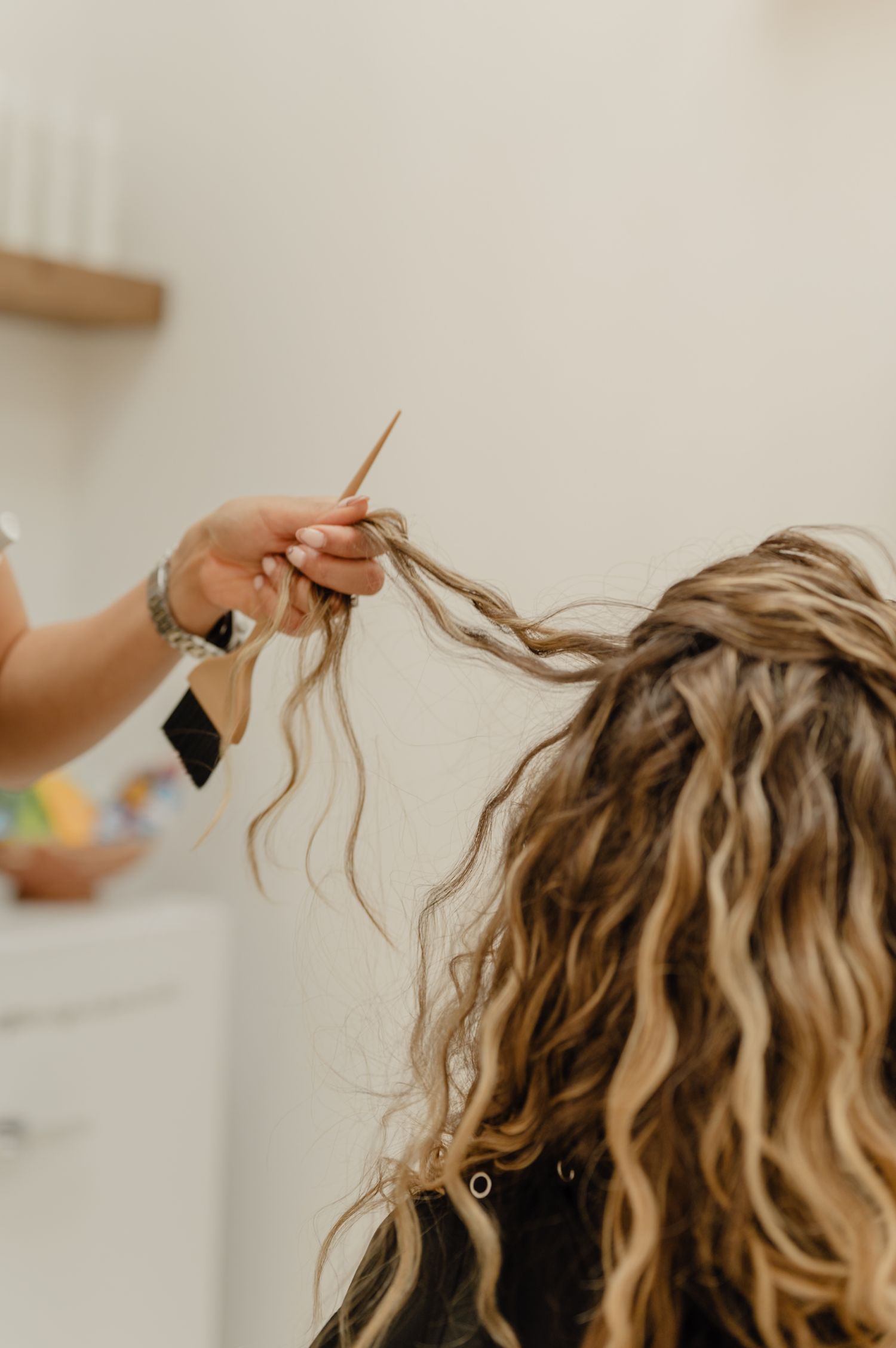 Detailed curl-by-curl styling—Serena Beach creates definition and bounce for curly hair clients at Salon Blissful.