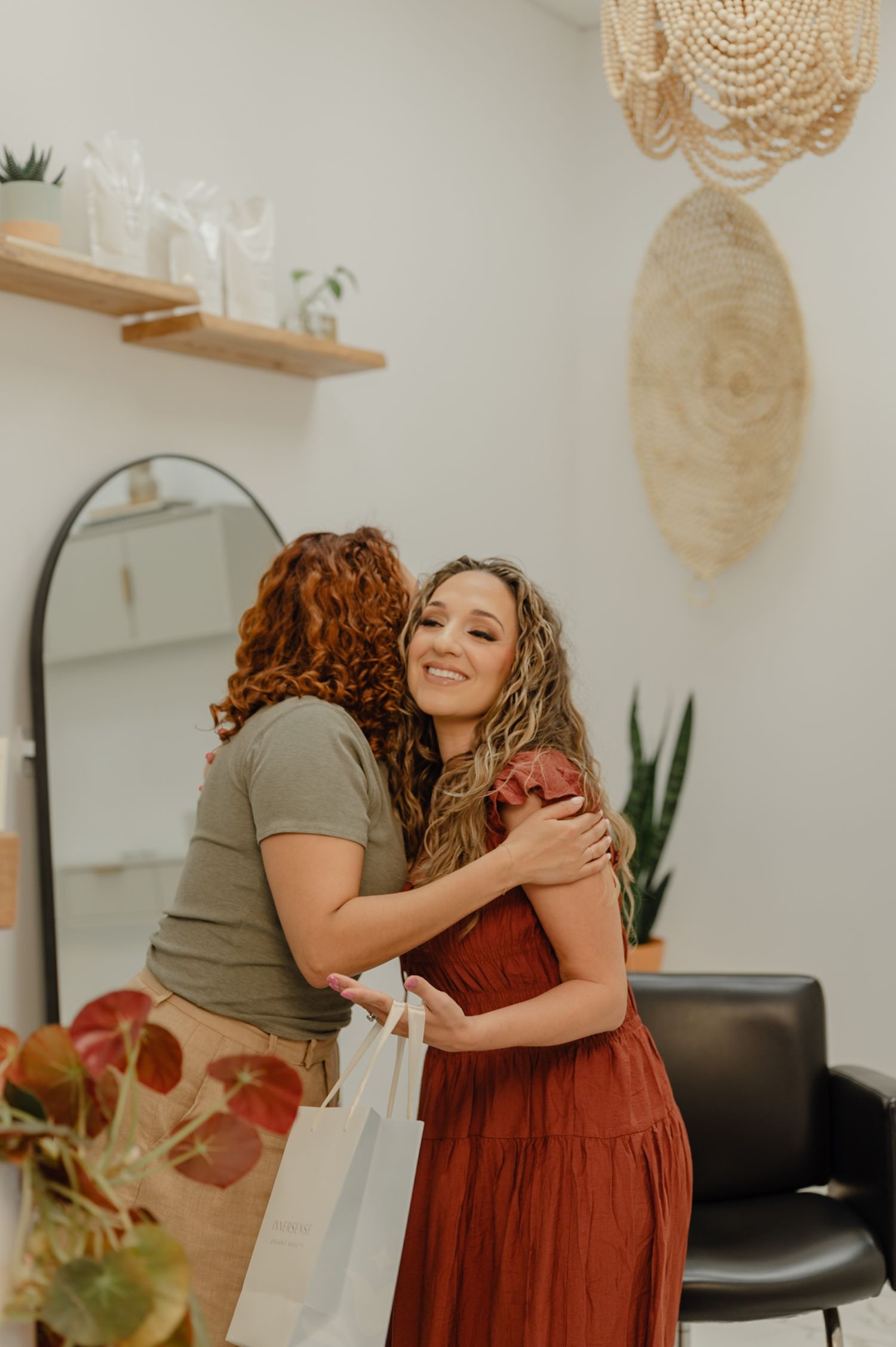 Serena hugging a client in her salon during a storytelling brand shoot that captured connection and care.