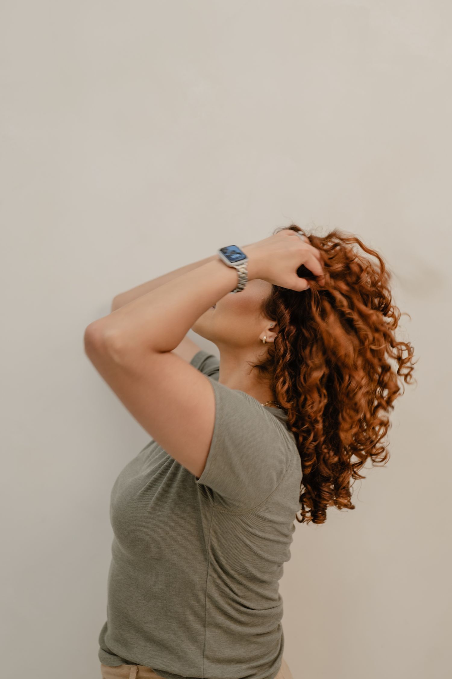 Serena showing off her curls in a natural, personality-filled portrait for her salon’s branding session.
