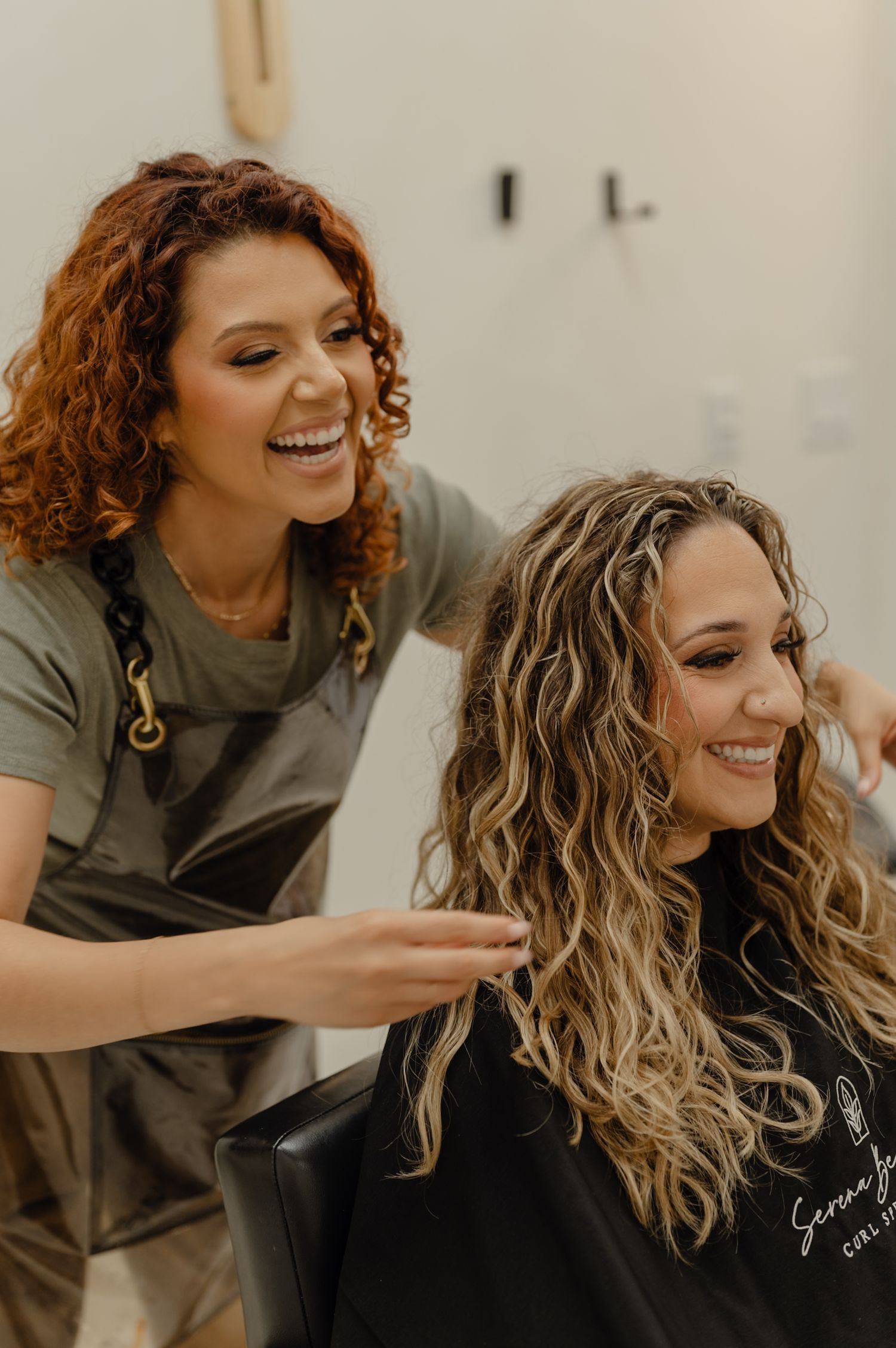 Close-up moment of Serena styling a client, showing trust, connection, and the client experience at Serena Beach Hair.
