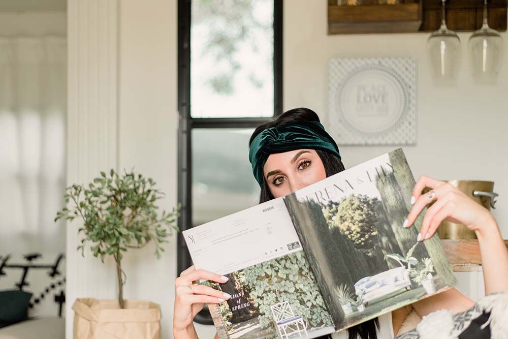 phoenix arizona influencer in her personal brand shoot with a green turban and serena and lily magazine in front of her face