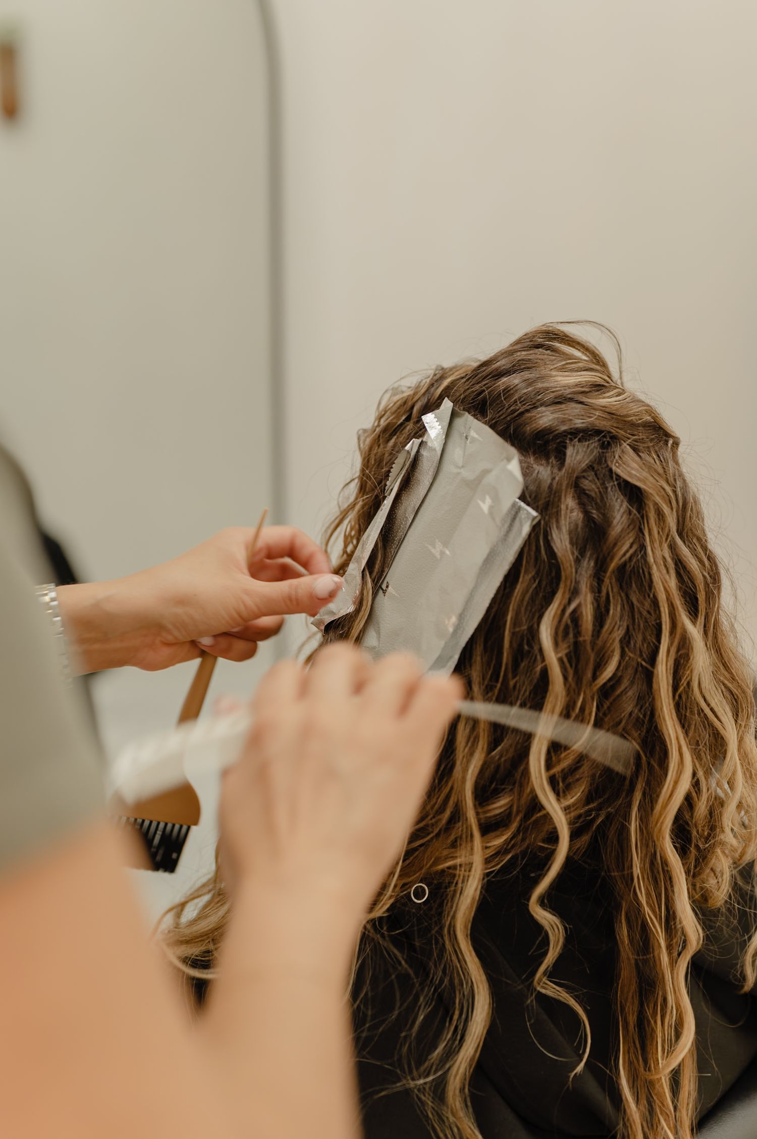 Custom curly cut in progress—Serena Beach, expert stylist at Salon Blissful, shaping healthy, defined natural curls.