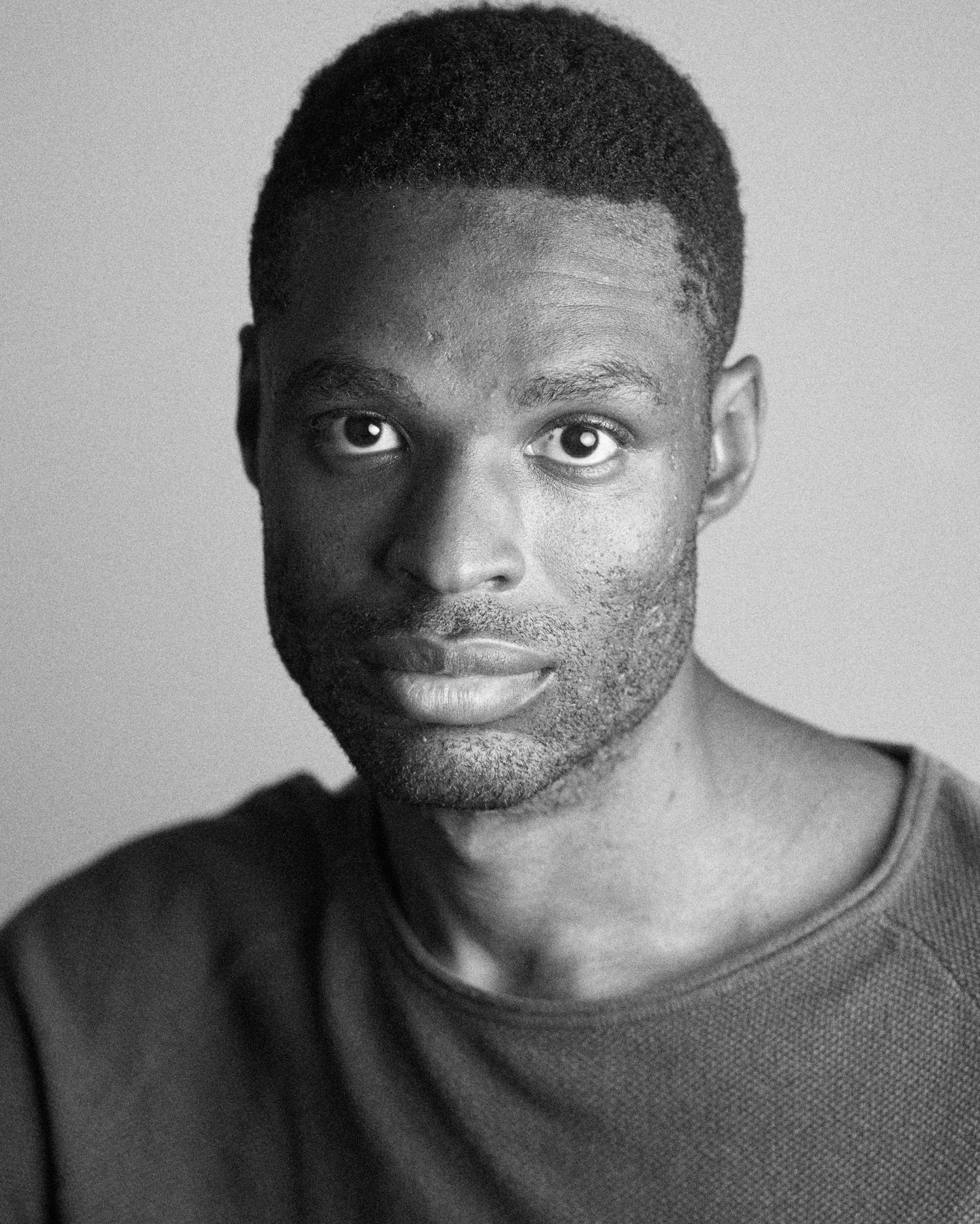 Black and white headshot series showing expressive facial expressions against light background.