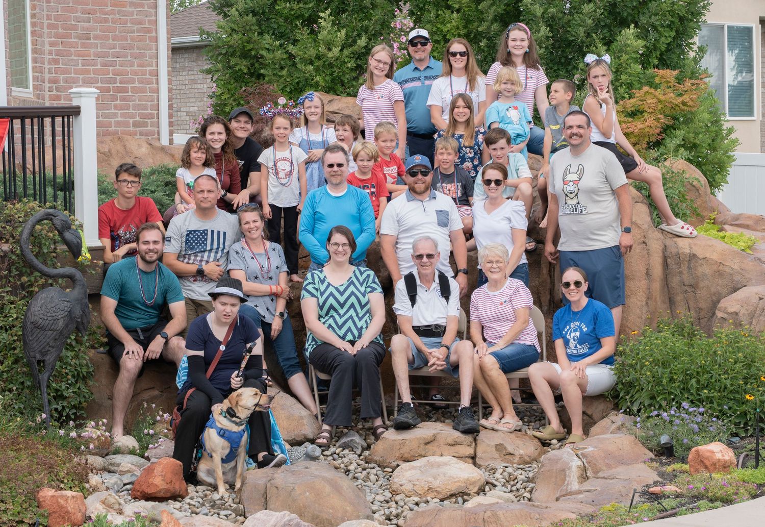 Large group photo of people gathered outside brick building.