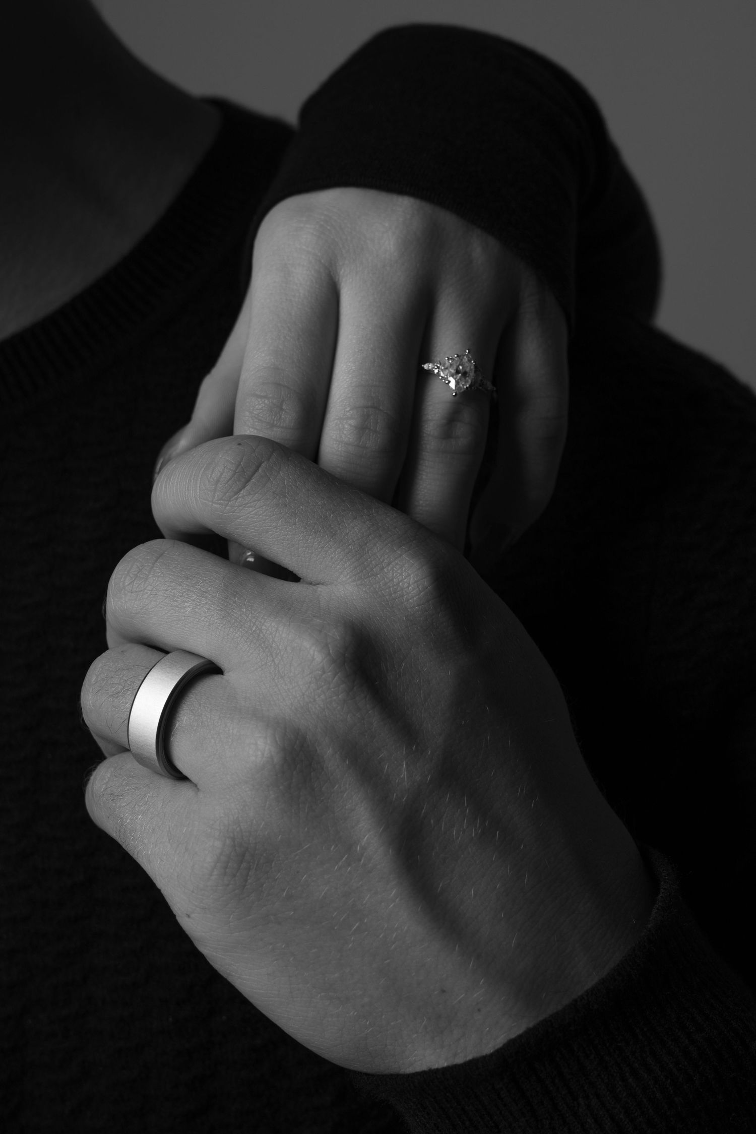 Black and white photo series showing close-up shots of hands wearing wedding rings and engagement rings.