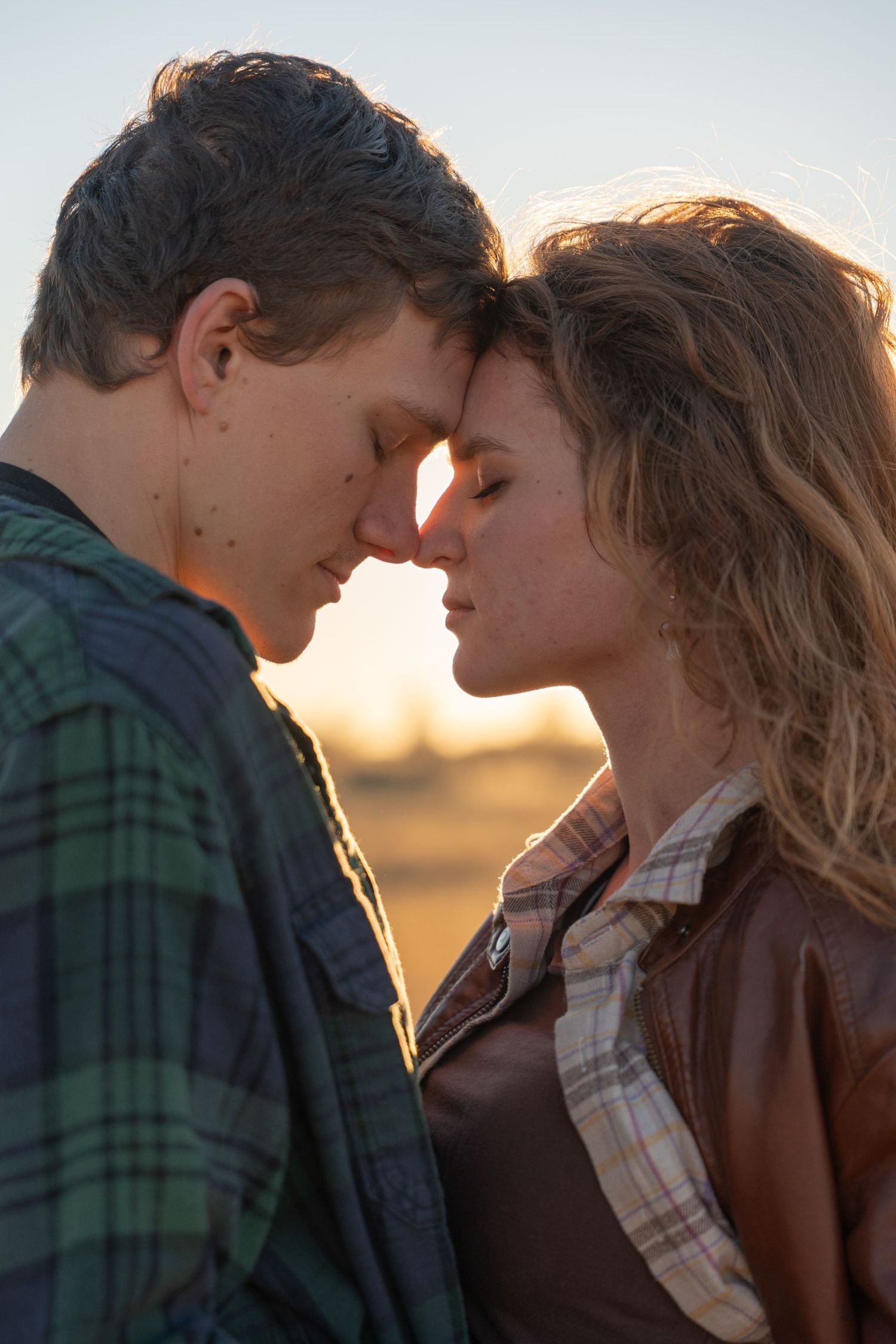 Intimate couple portraits at sunset with a green plaid shirt and brown leather jacket.