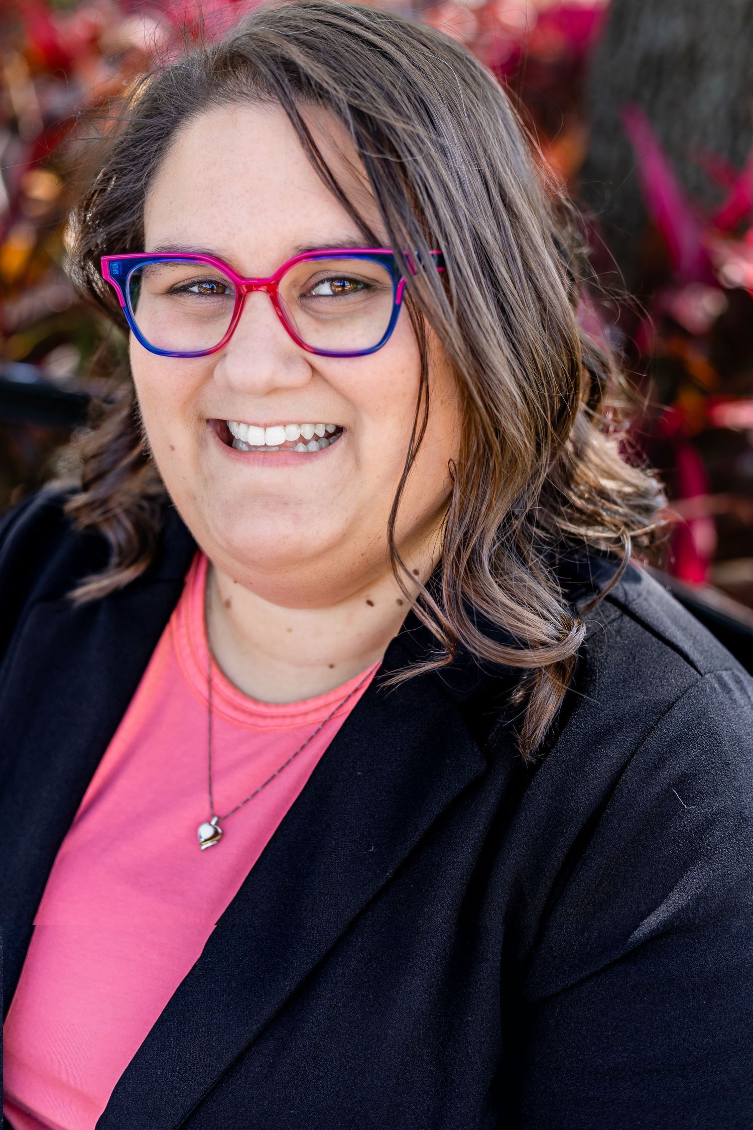 Bright, confident headshot with natural light and a friendly, approachable smile.