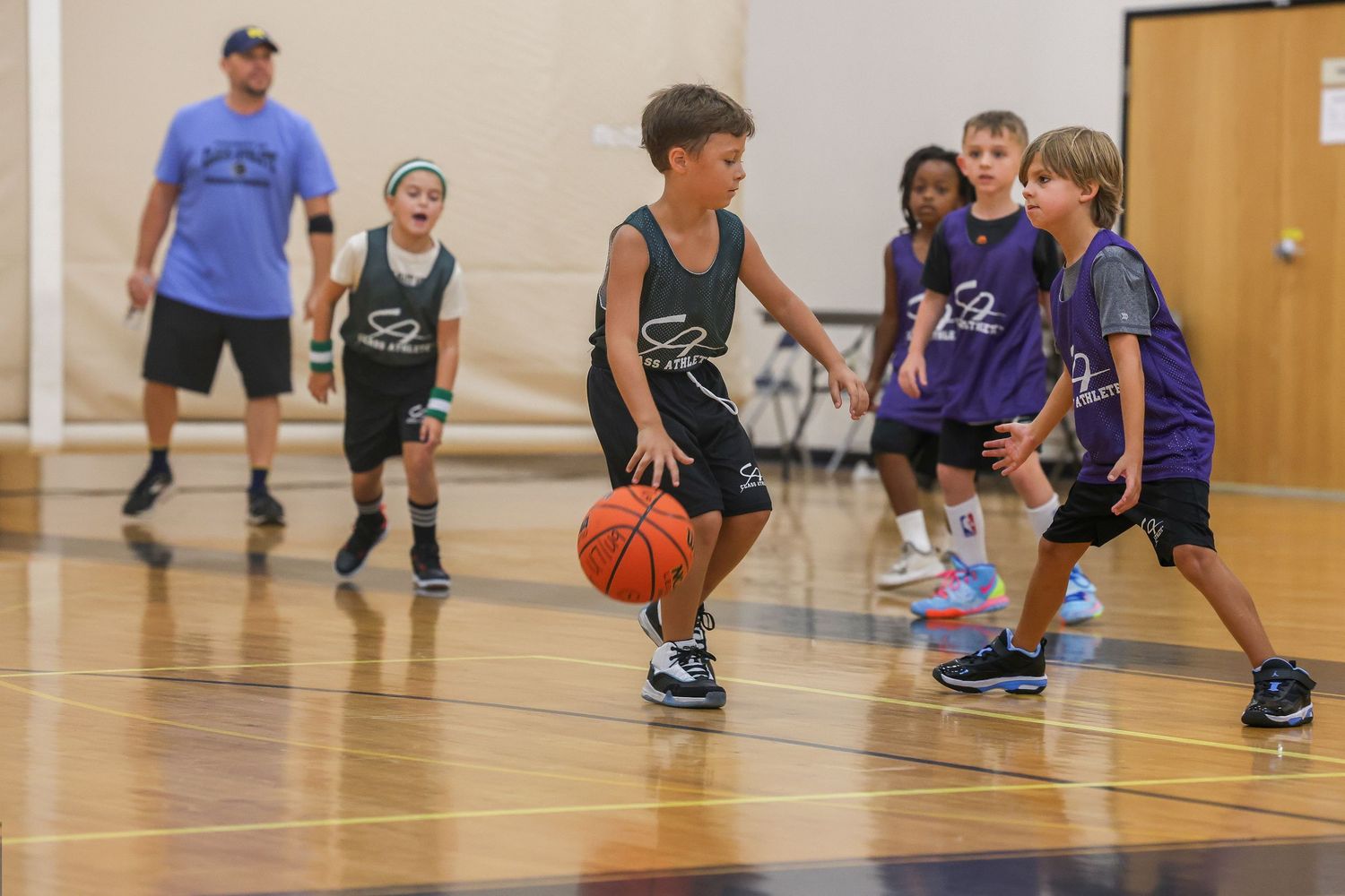 Action packed indoor basketball shot showing teamwork, energy, and focus on the court.