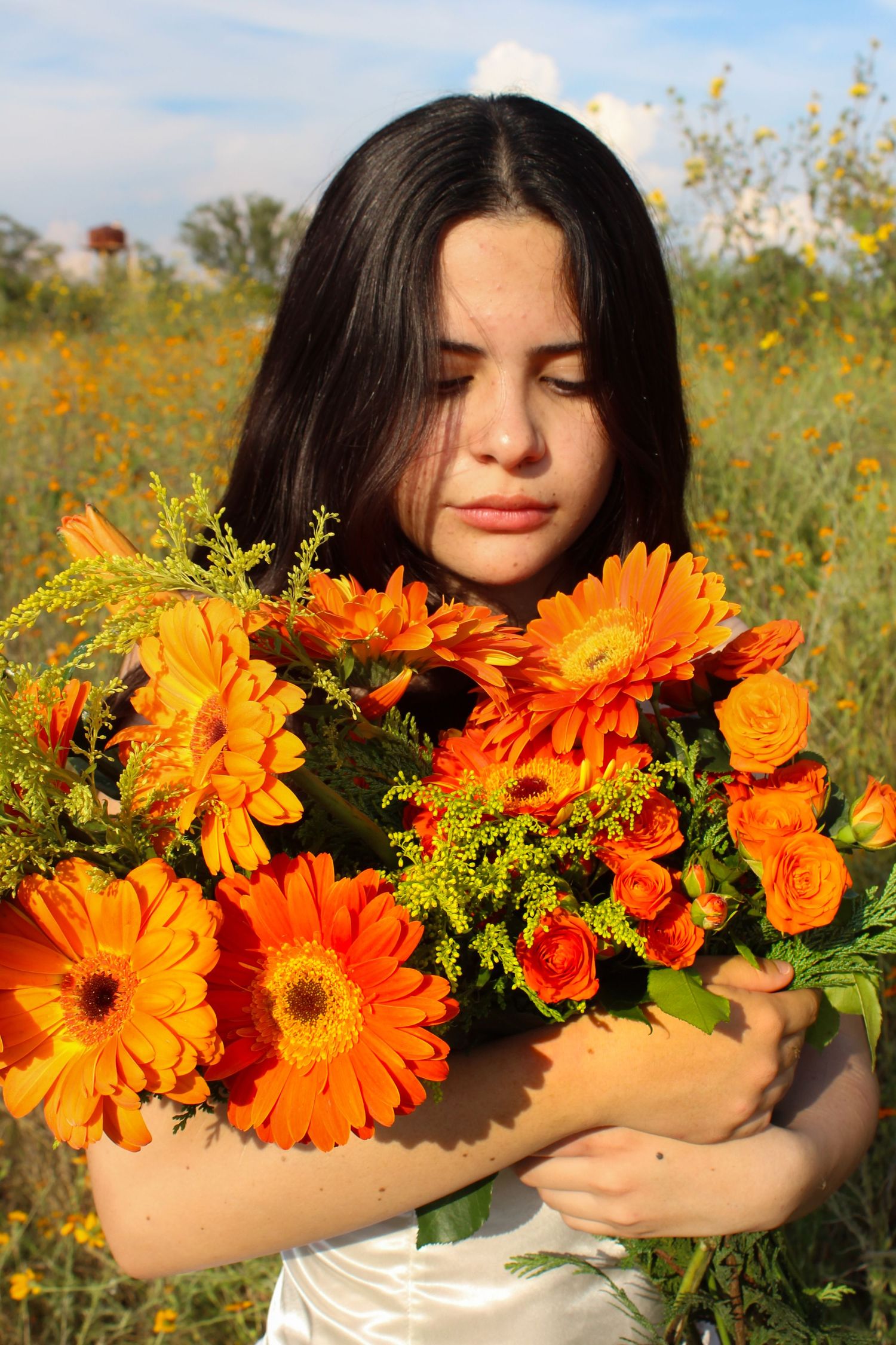 girl with orange flowers looking down