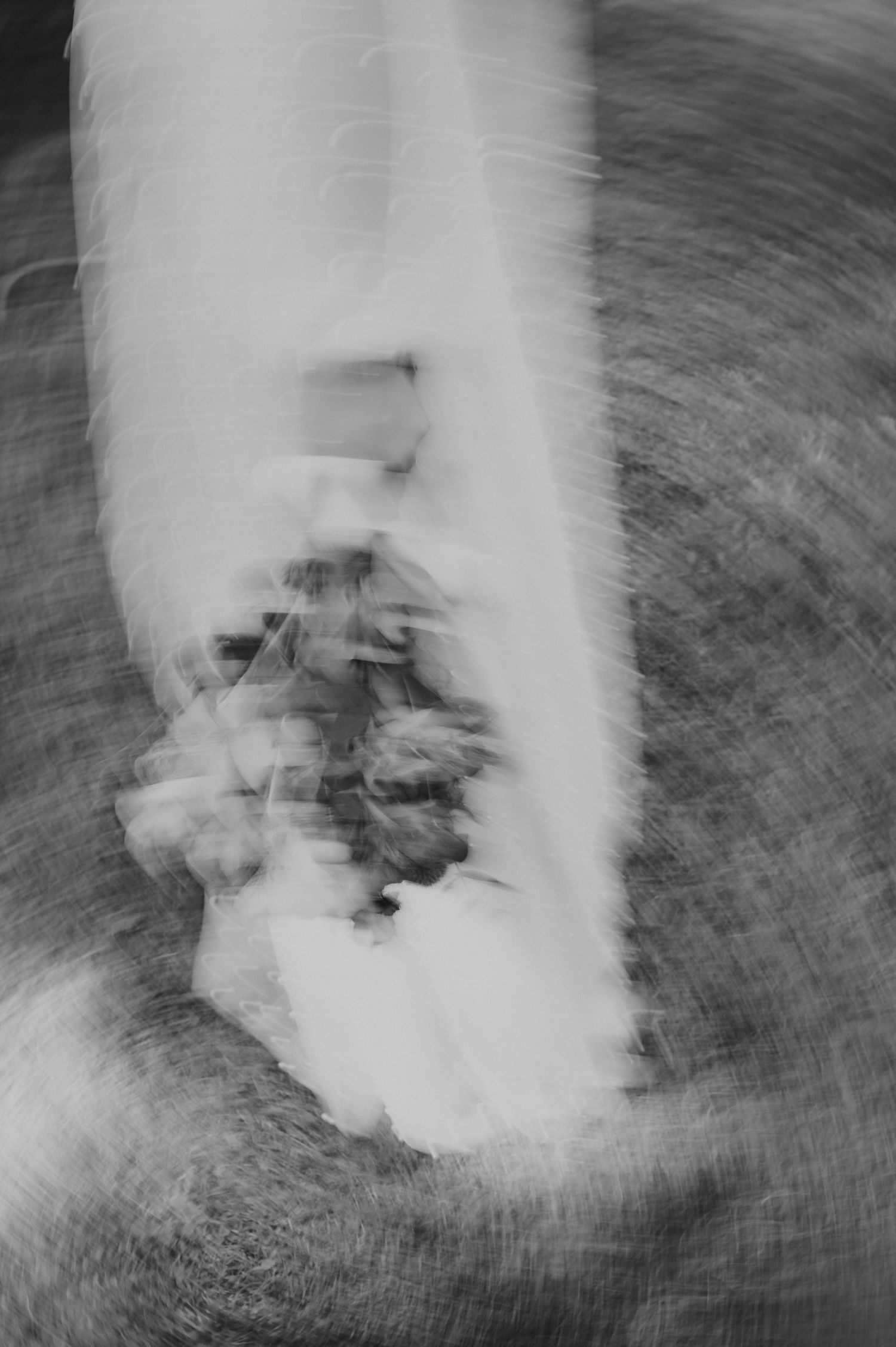 Abstract black and white motion blur photo of wedding dress bouquet with spinning effect. wedding photographer in mendoza