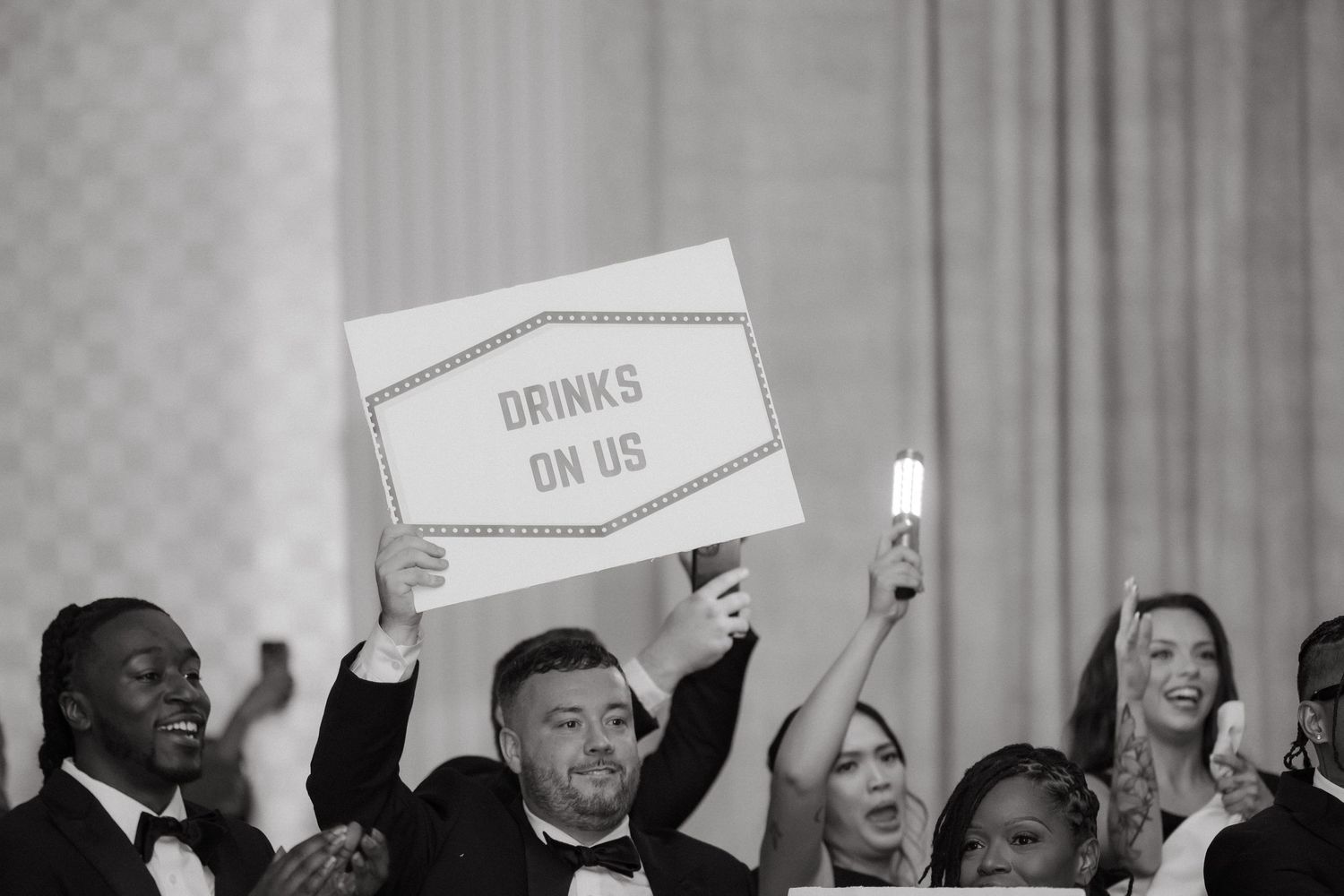 Wedding guests celebrate holding a 