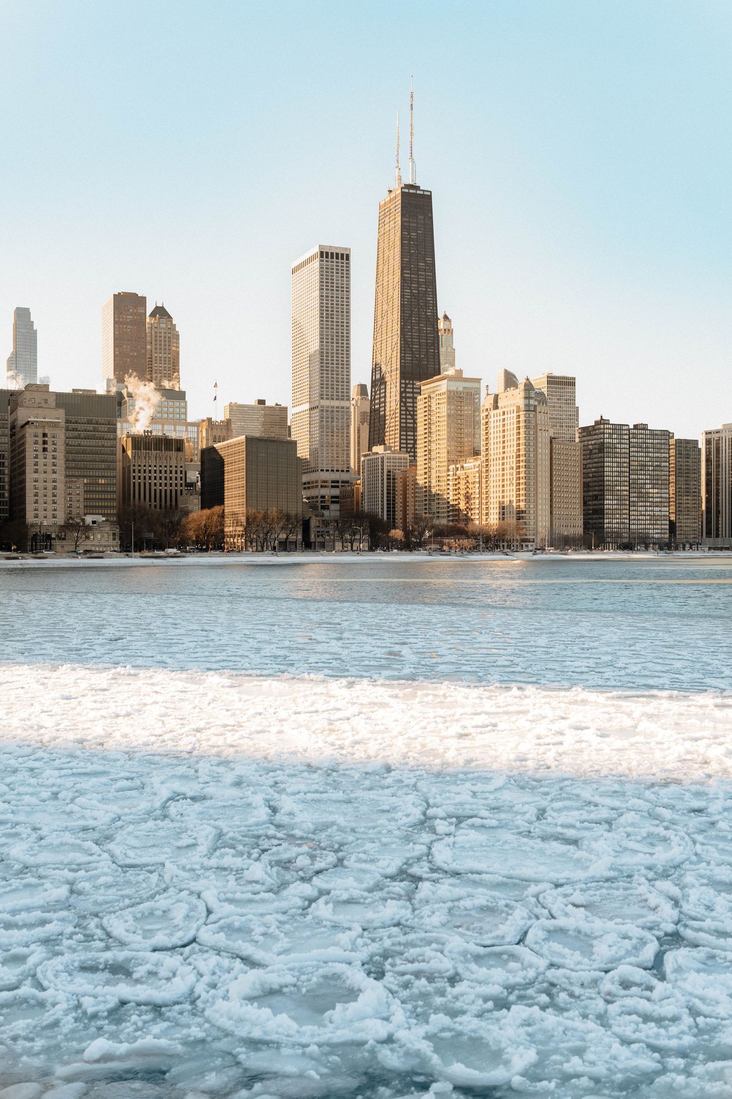 Chicago skyline viewed across a frozen icy Lake Michigan on a clear winter day.
