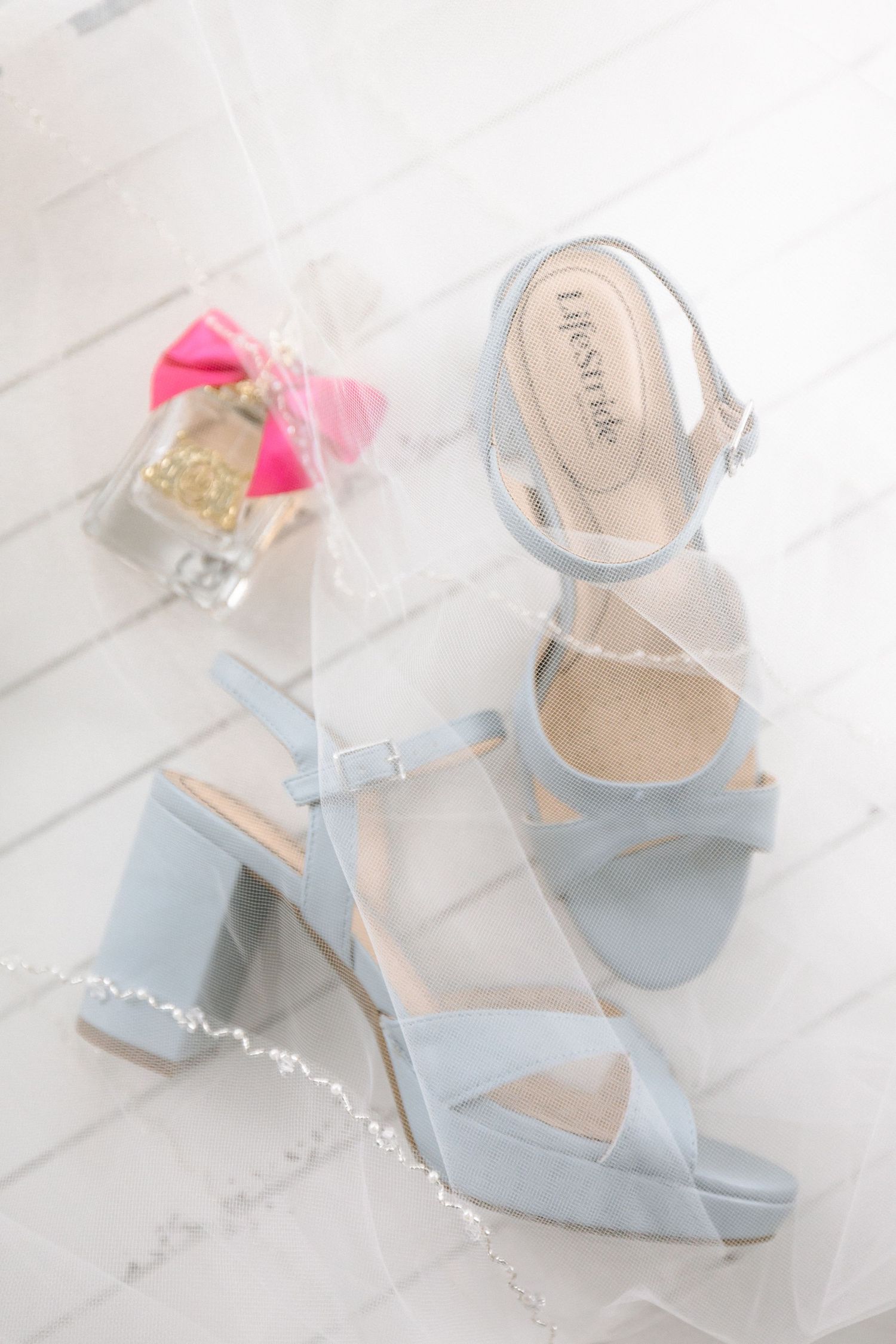 Light blue block heel sandals by Lifestride displayed on white tile for a wedding day bridal look.