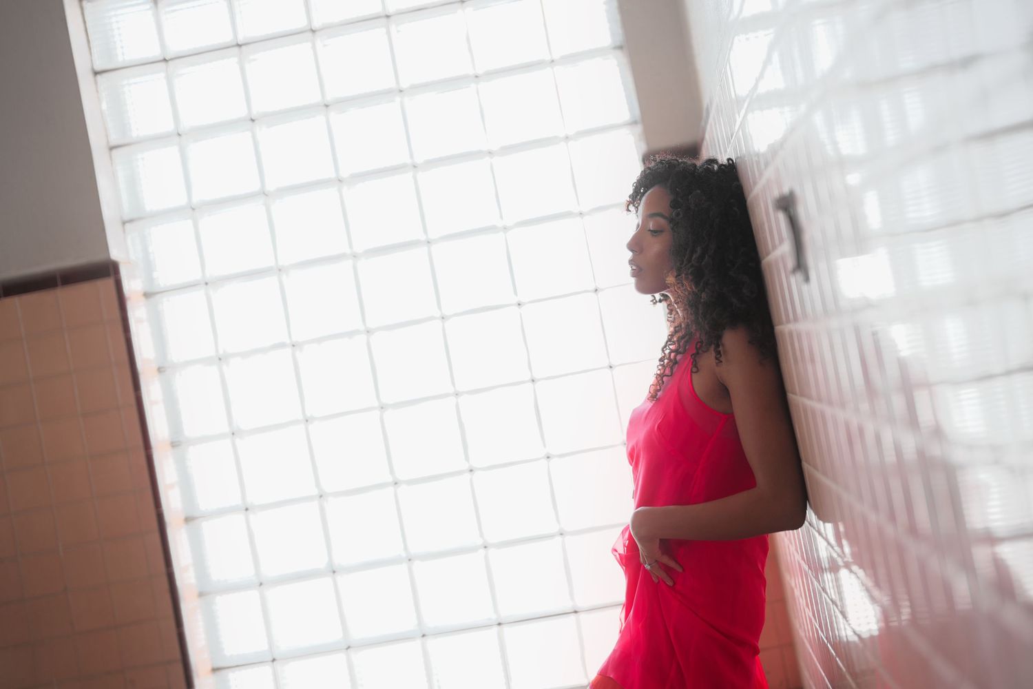 Woman leaning on wall.
