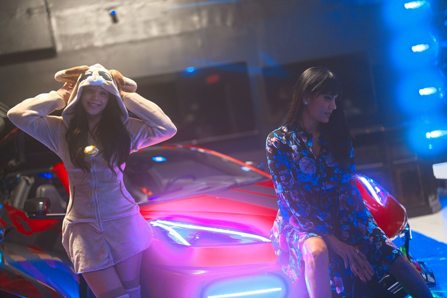 Women with car and abstract lighting.