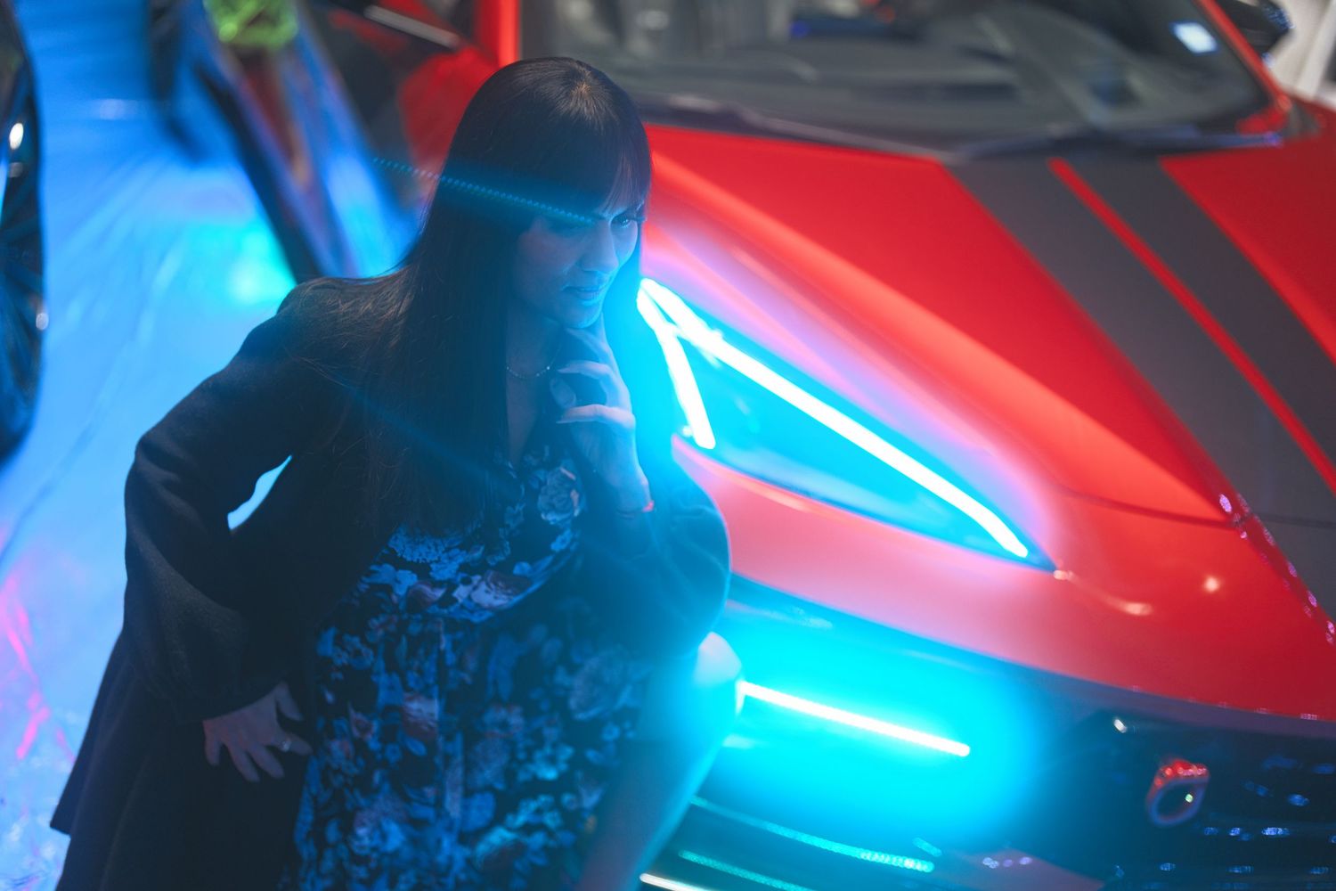Woman with car and abstract lighting.