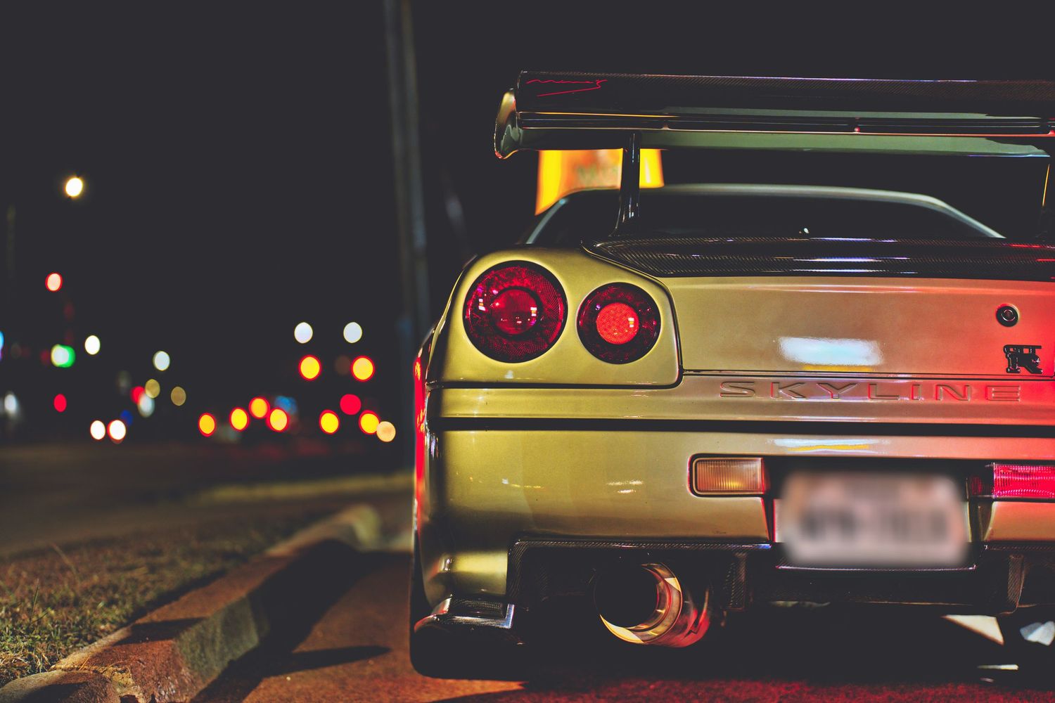 Nissan Skyline GTR R34 parked at night time.