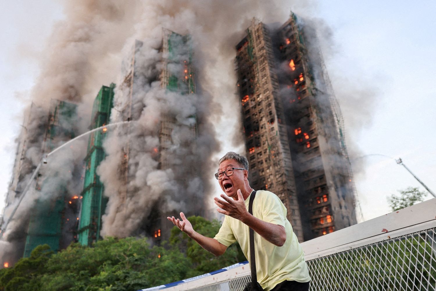 Wong, 71, shouts in anguish as Wang Fuk Court burns behind him during Hong Kong's deadliest fire in decades, Tai Po, Nov. 2025.
