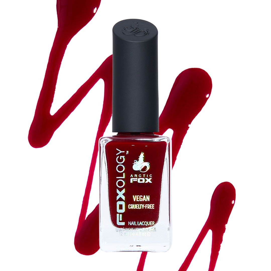 Arctic Fox Foxology vegan cruelty-free deep red nail lacquer bottle with glossy crimson swatch background.