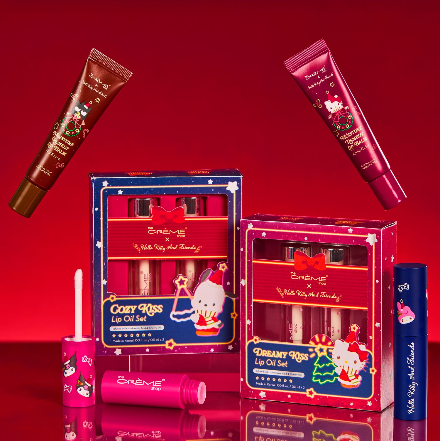 Hello Kitty x Colourpop Cozy Kiss and Dreamy Kiss Lip Oil Sets displayed on a festive red background.