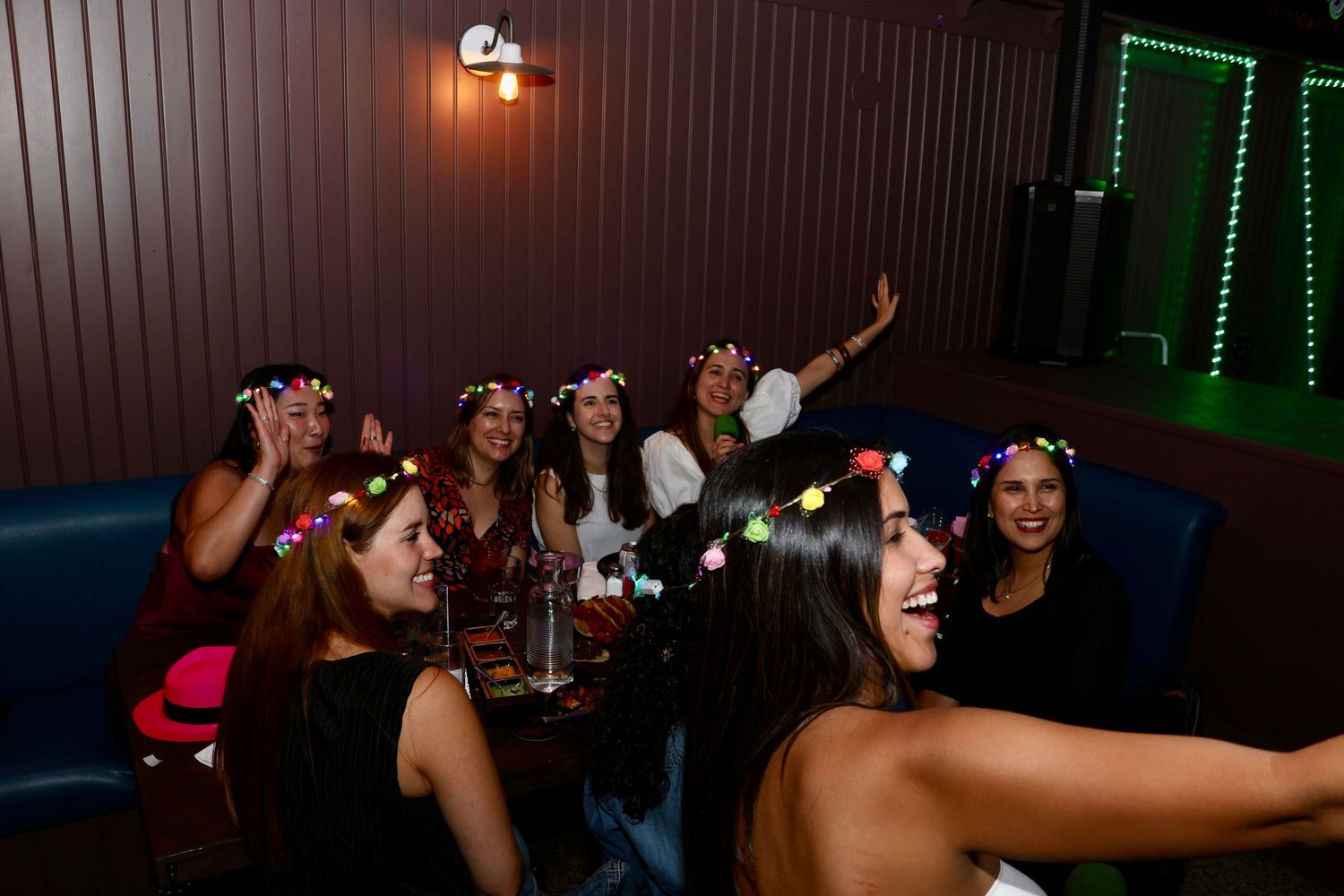 Dark nightclub interior with green LED strip lighting and party atmosphere.