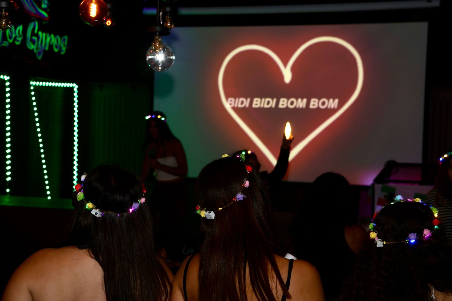 Nightclub interior with neon heart sign and colorful lights creating a romantic atmosphere.
