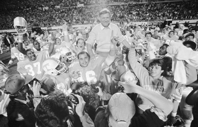 Black and white photo of an energetic crowd celebration at a sporting event.