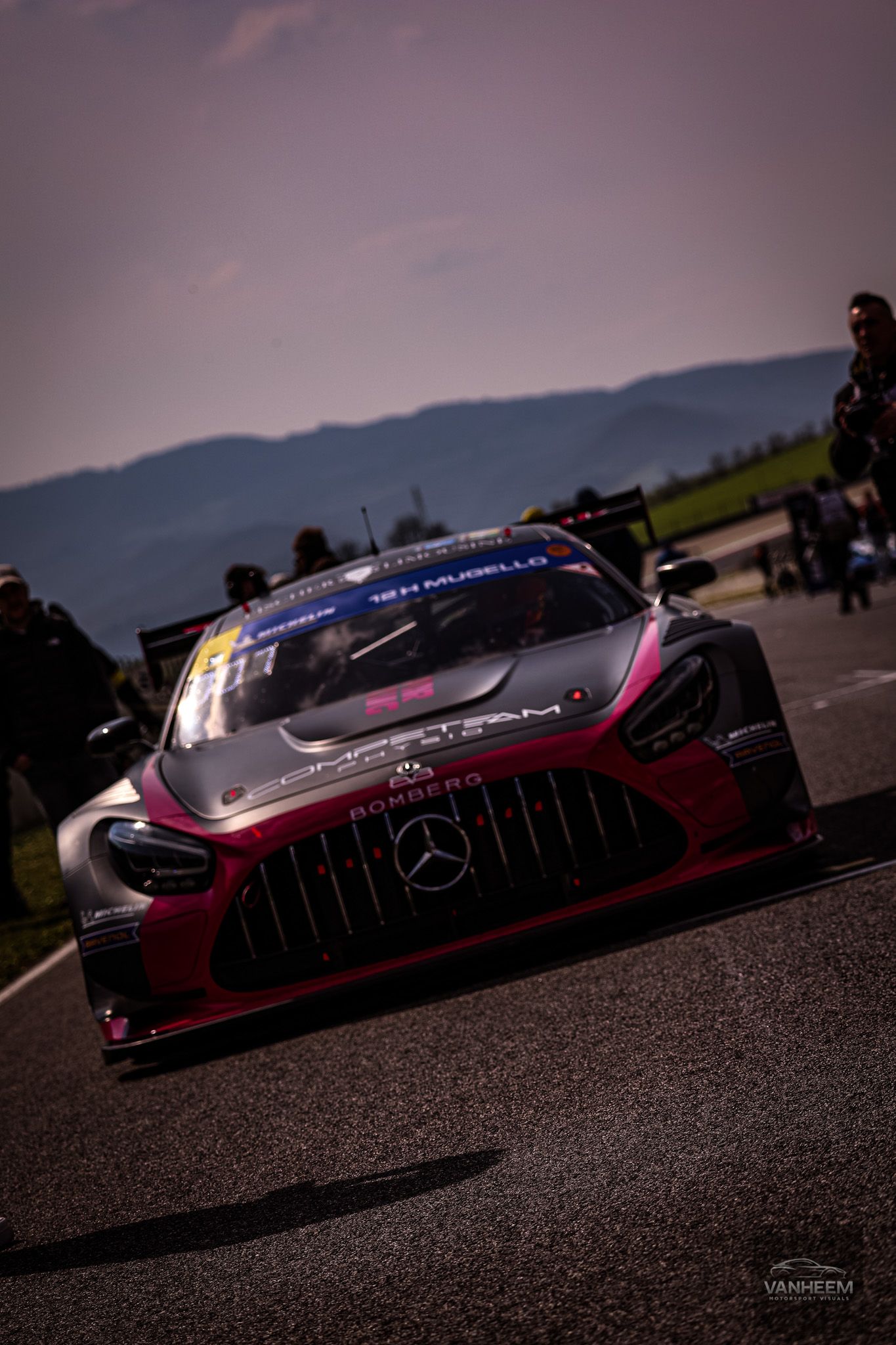 A series of dark moody shots showing a Mercedes AMG GT3 race car in burgundy and black against a dramatic evening sky.