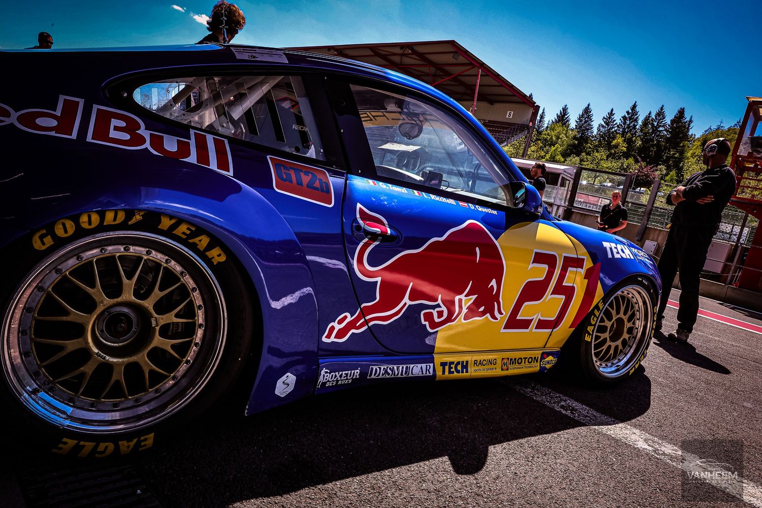 Red Bull Racing car number 25 with Goodyear Eagle tires on a sunny race track pit lane.
