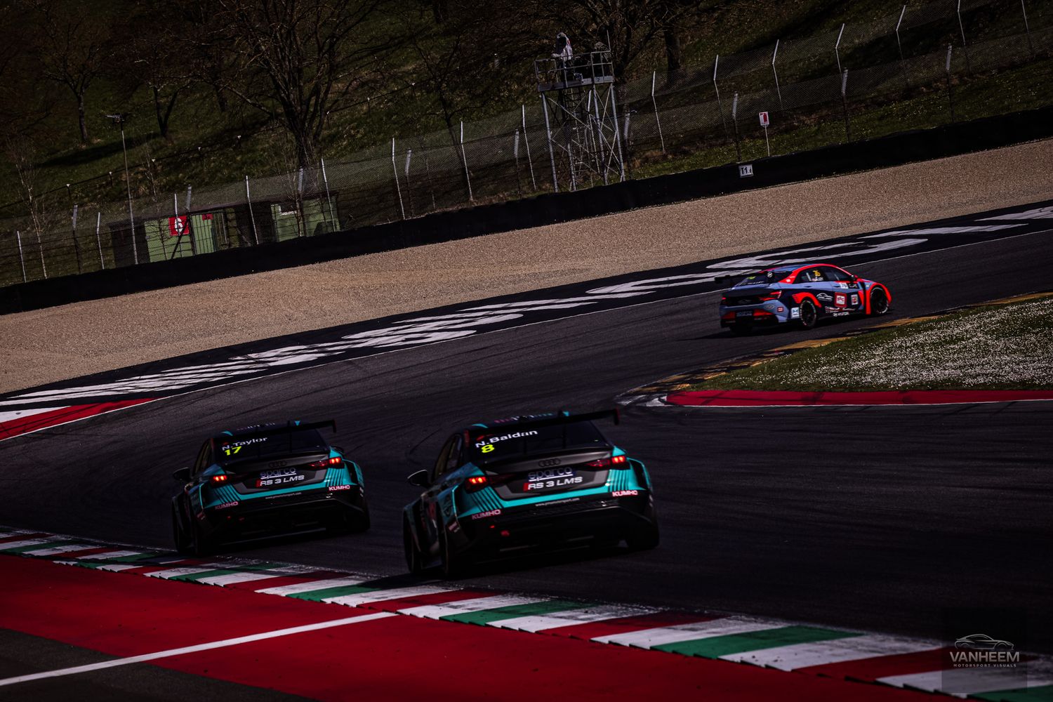 Formula One race car navigates through a challenging turn on a professional racing circuit during competition.