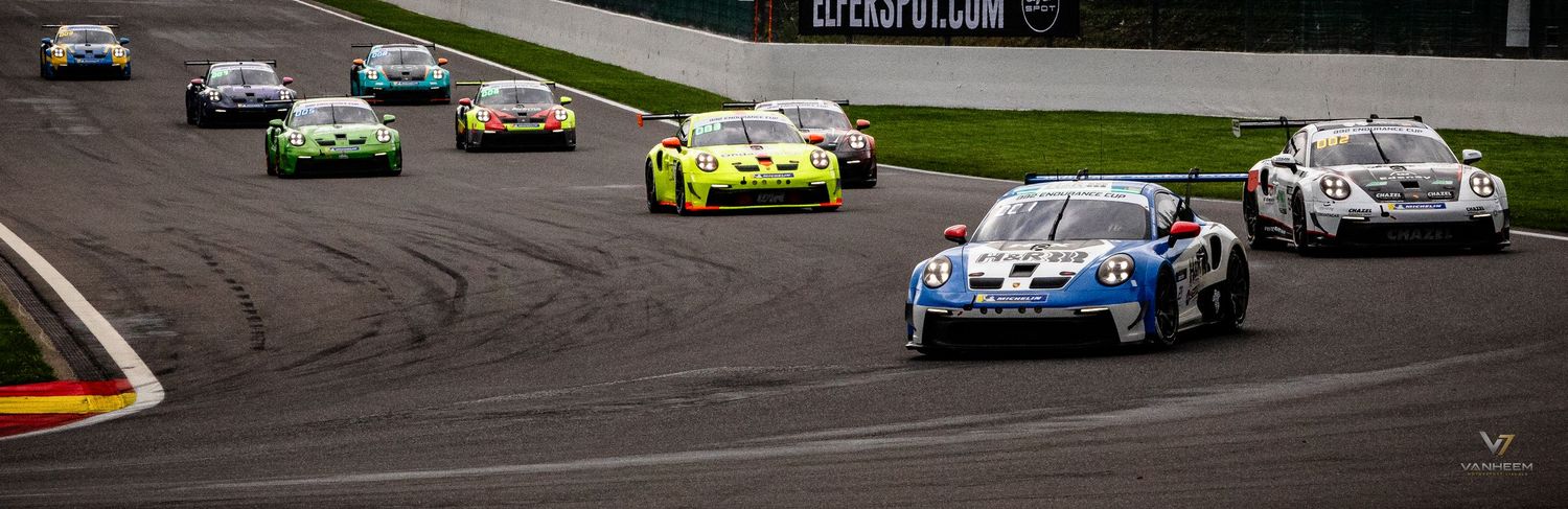 Multiple Porsche GT3 race cars competing on a circuit track during a professional motorsport racing event.