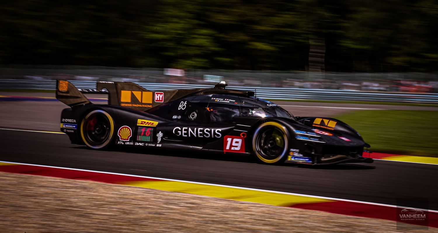 Black Genesis No. 19 LMP race car speeding on track at Spa-Francorchamps circuit during endurance race.